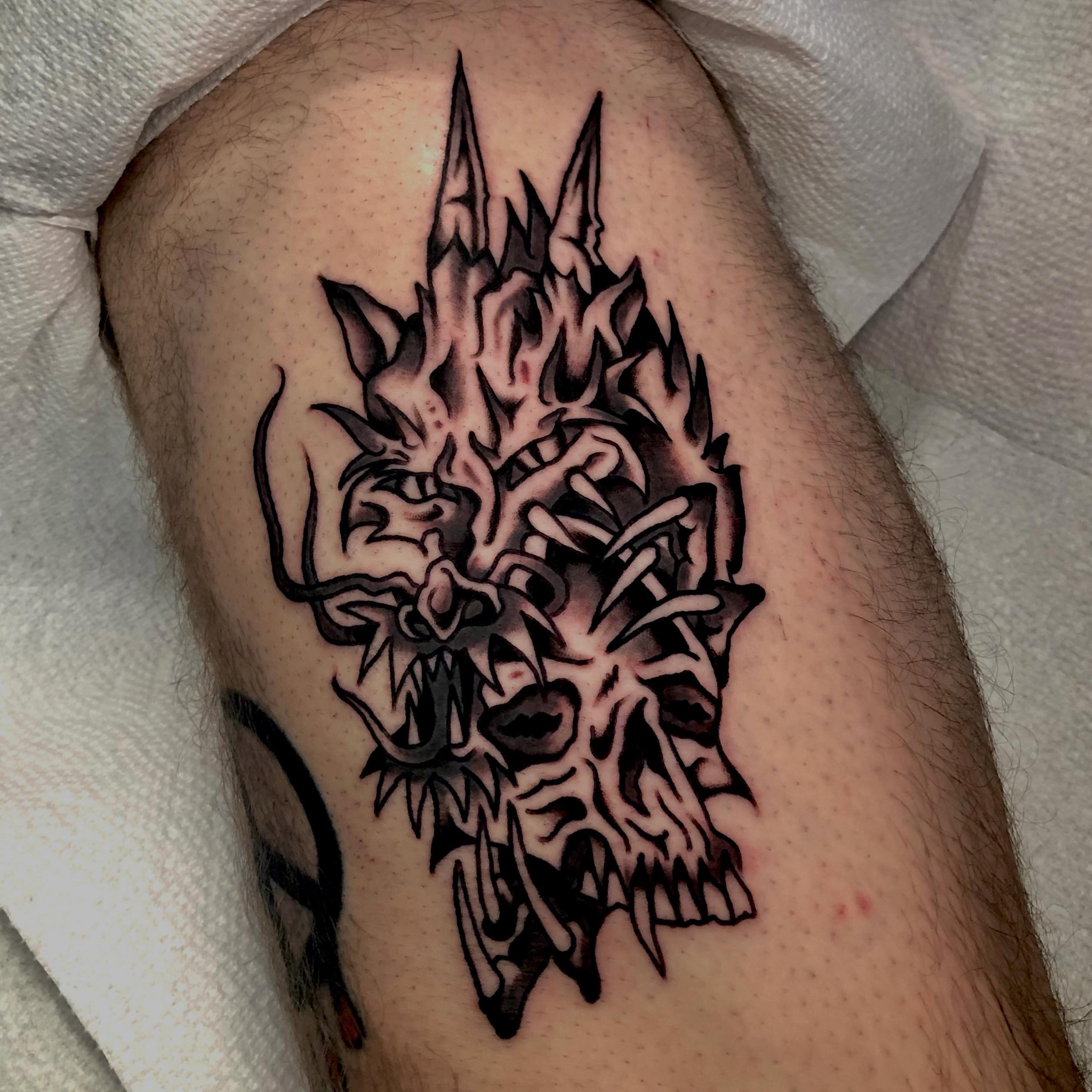Skull black and grey tattoo on the thigh by brenden