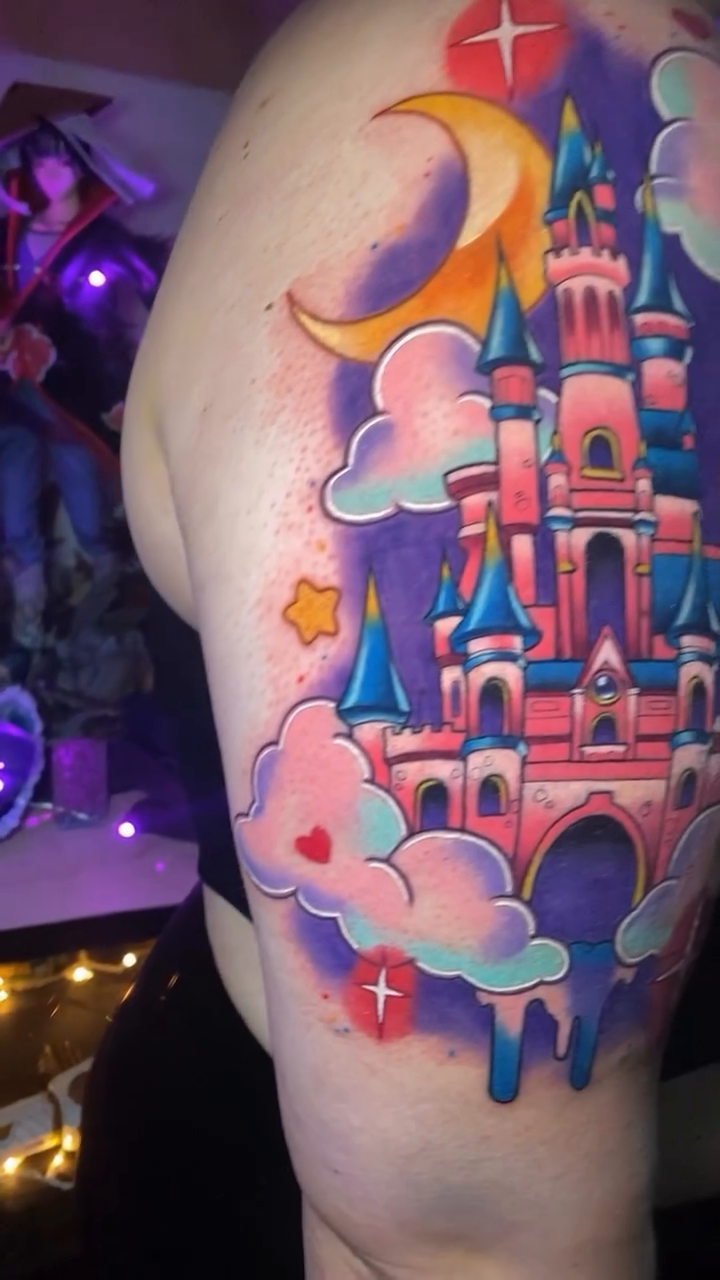Pink castle with clouds and moon new school tattoo on the shoulder by Tattertot