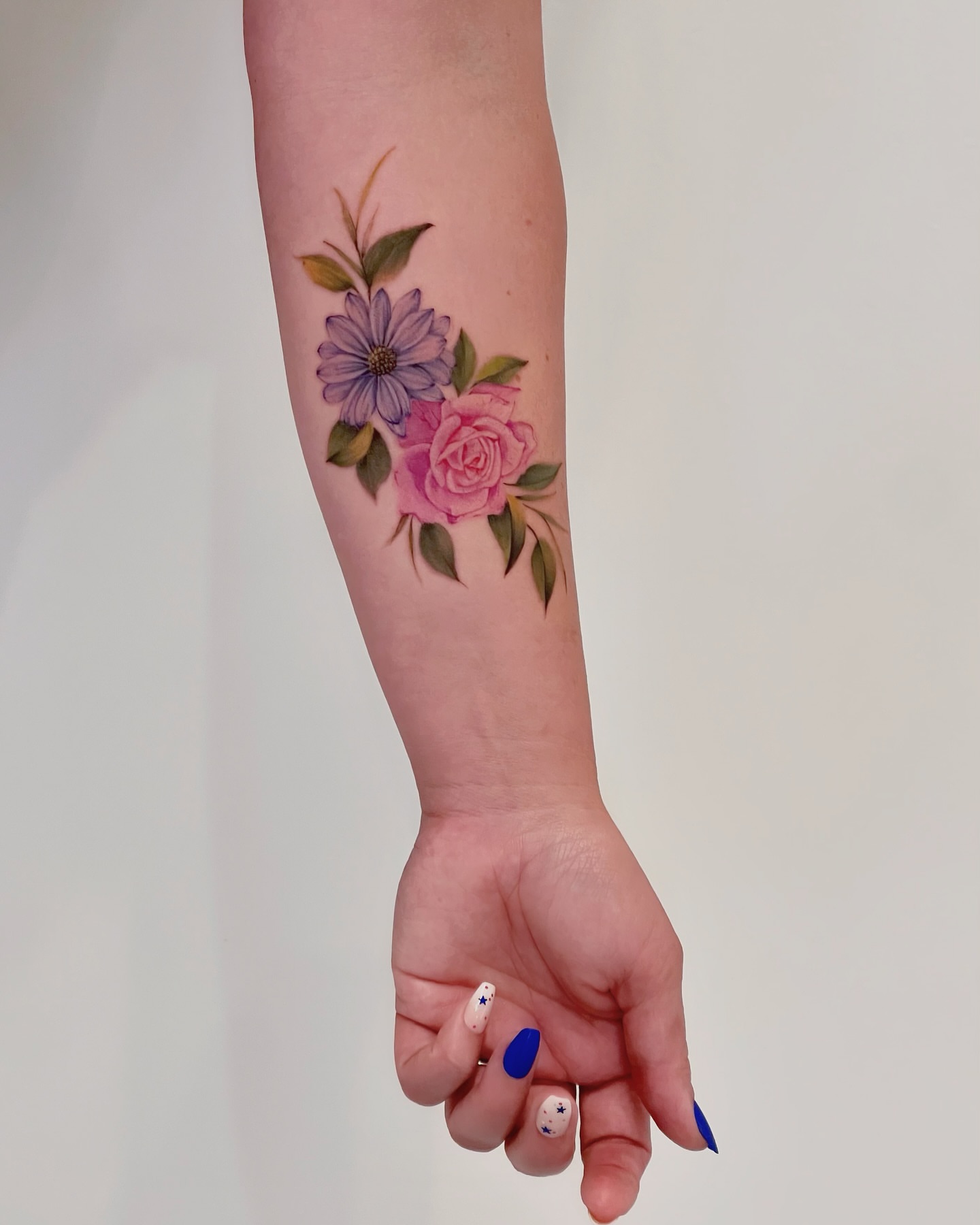Floral arrangement watercolor tattoo on the forearm by Seattle Tattoo Artist PingPing, Seattle, Washington