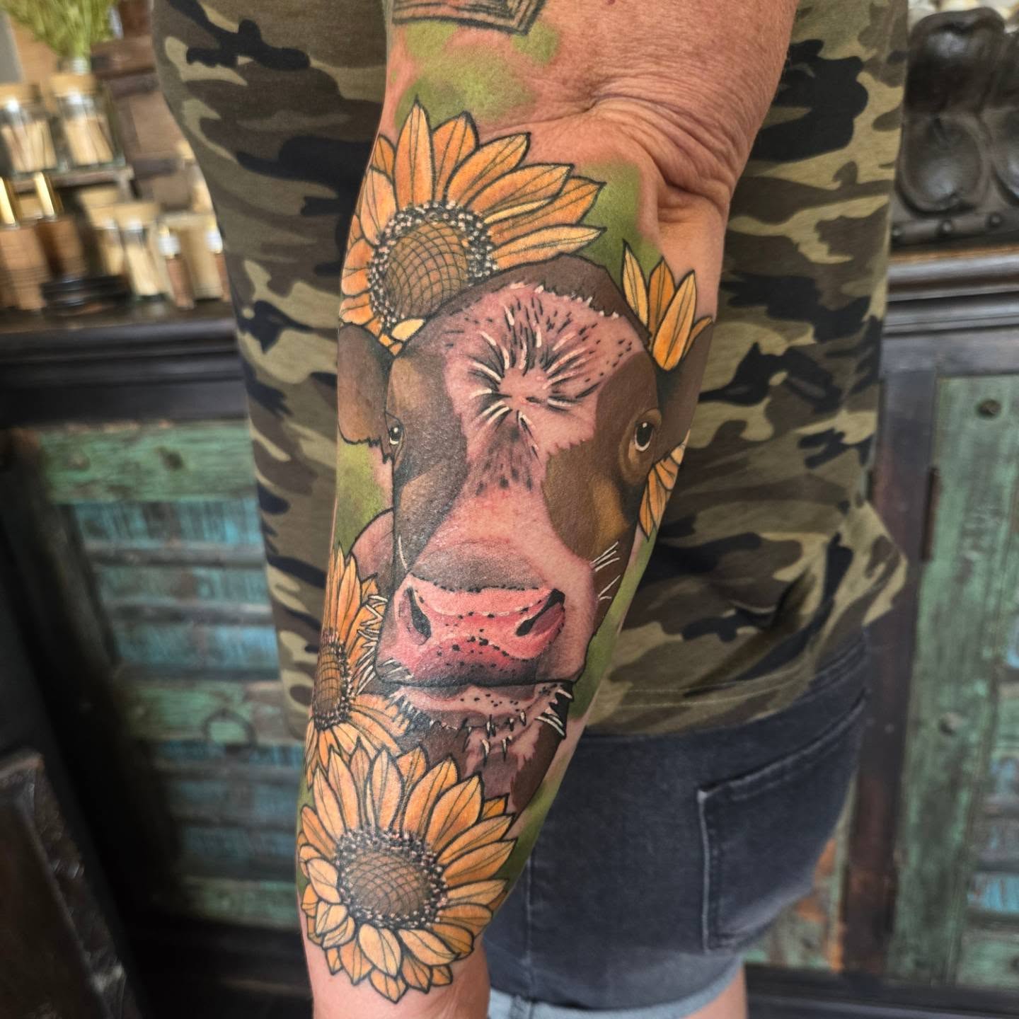 Cow and sunflowers realism tattoo on the forearm by Brian Savage, Gilbert, Arizona