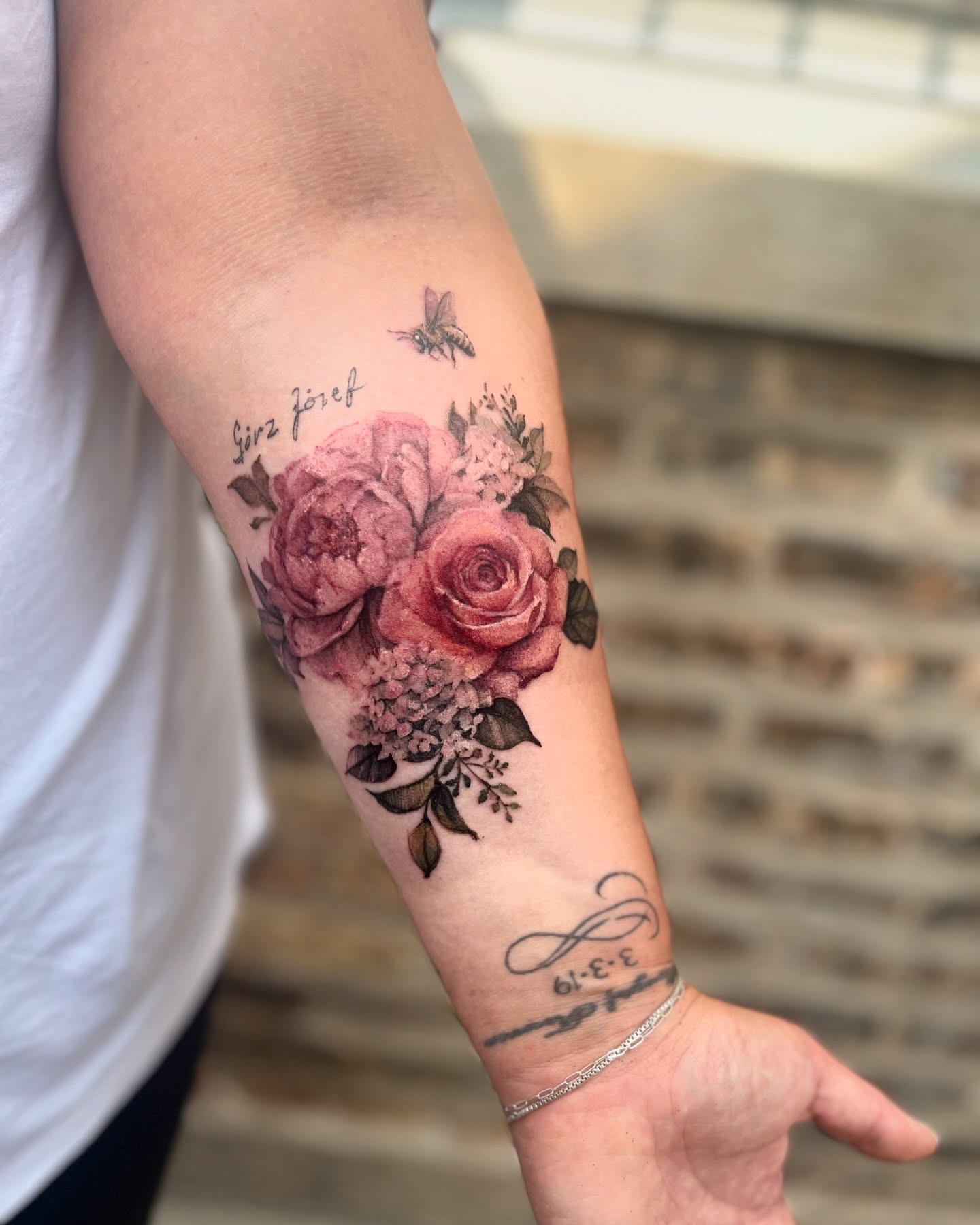 Floral bouquet realism tattoo on the forearm by Sarah Spread