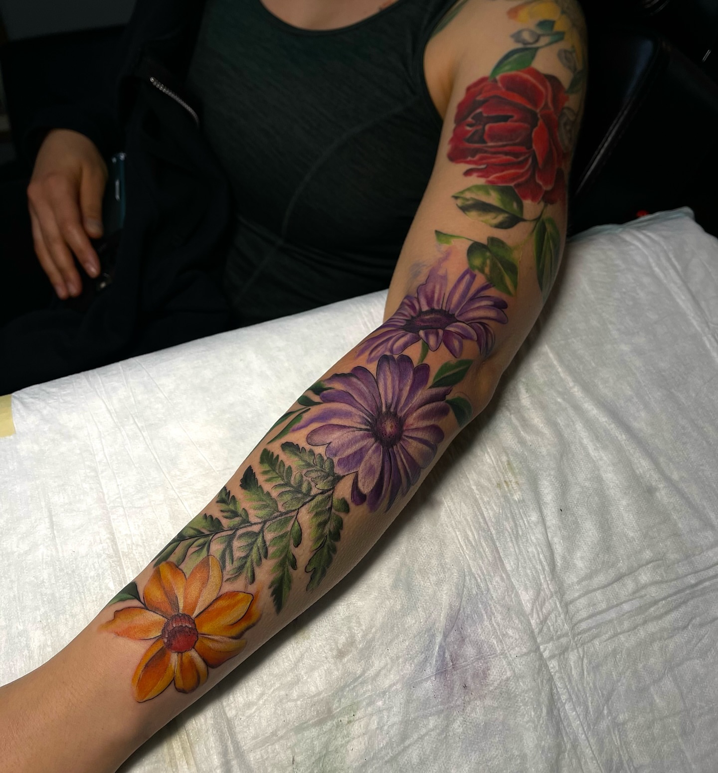 Floral bouquet realism tattoo on the forearm by Brittany Welsh, Marlton, New Jersey