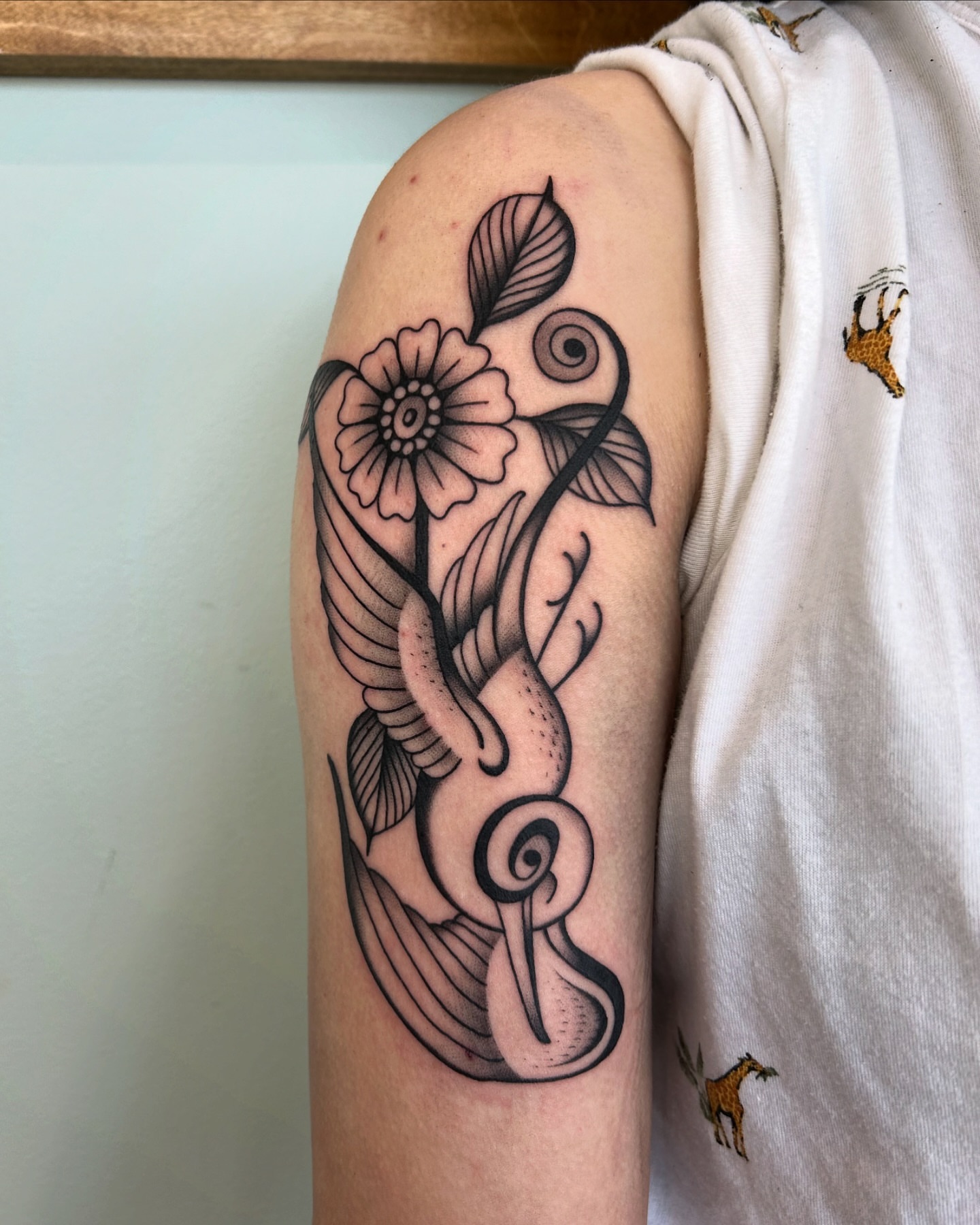 Flower and snake black and grey tattoo on the forearm by Lilly Binns