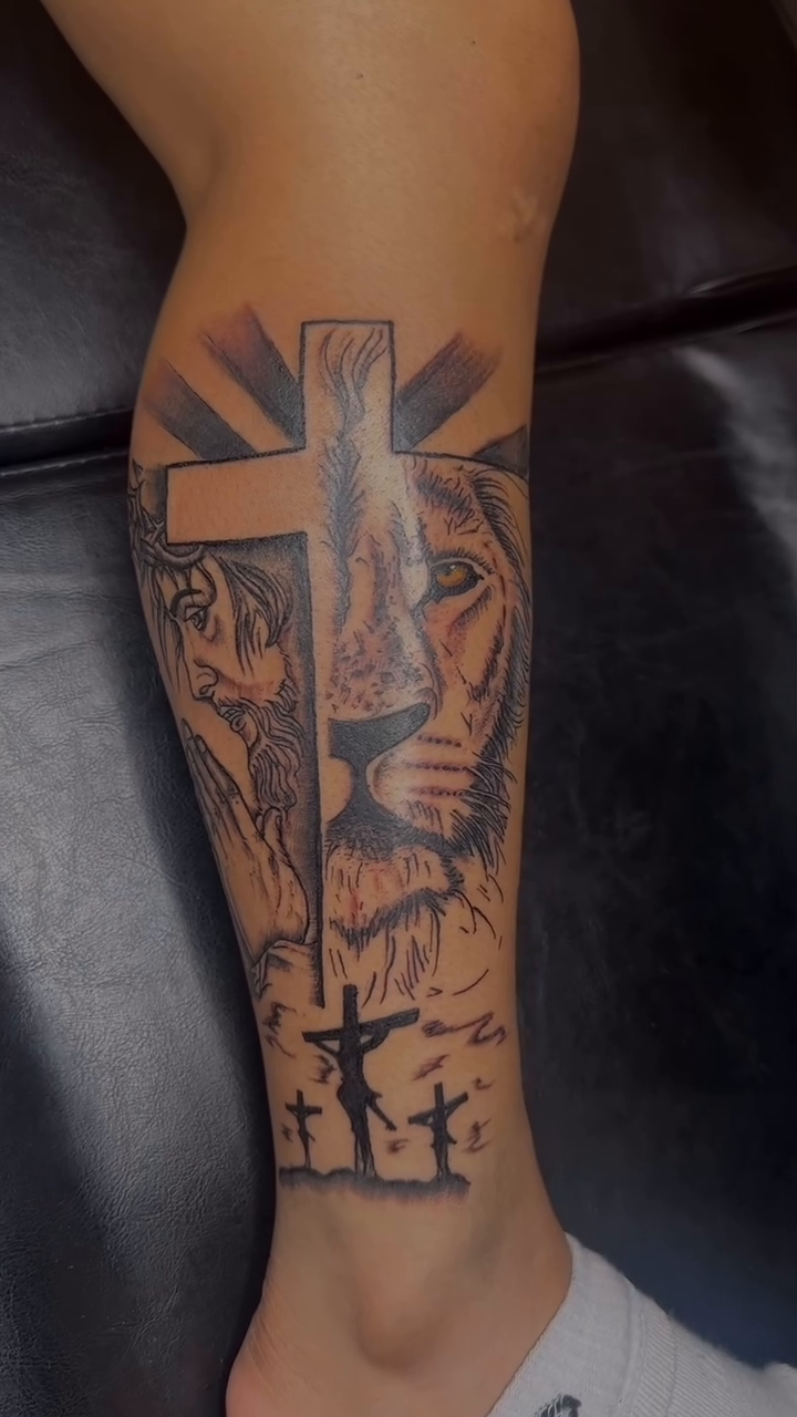 Lion and cross with figures realism tattoo by Bay Area Tattoo Artist ✍🏽