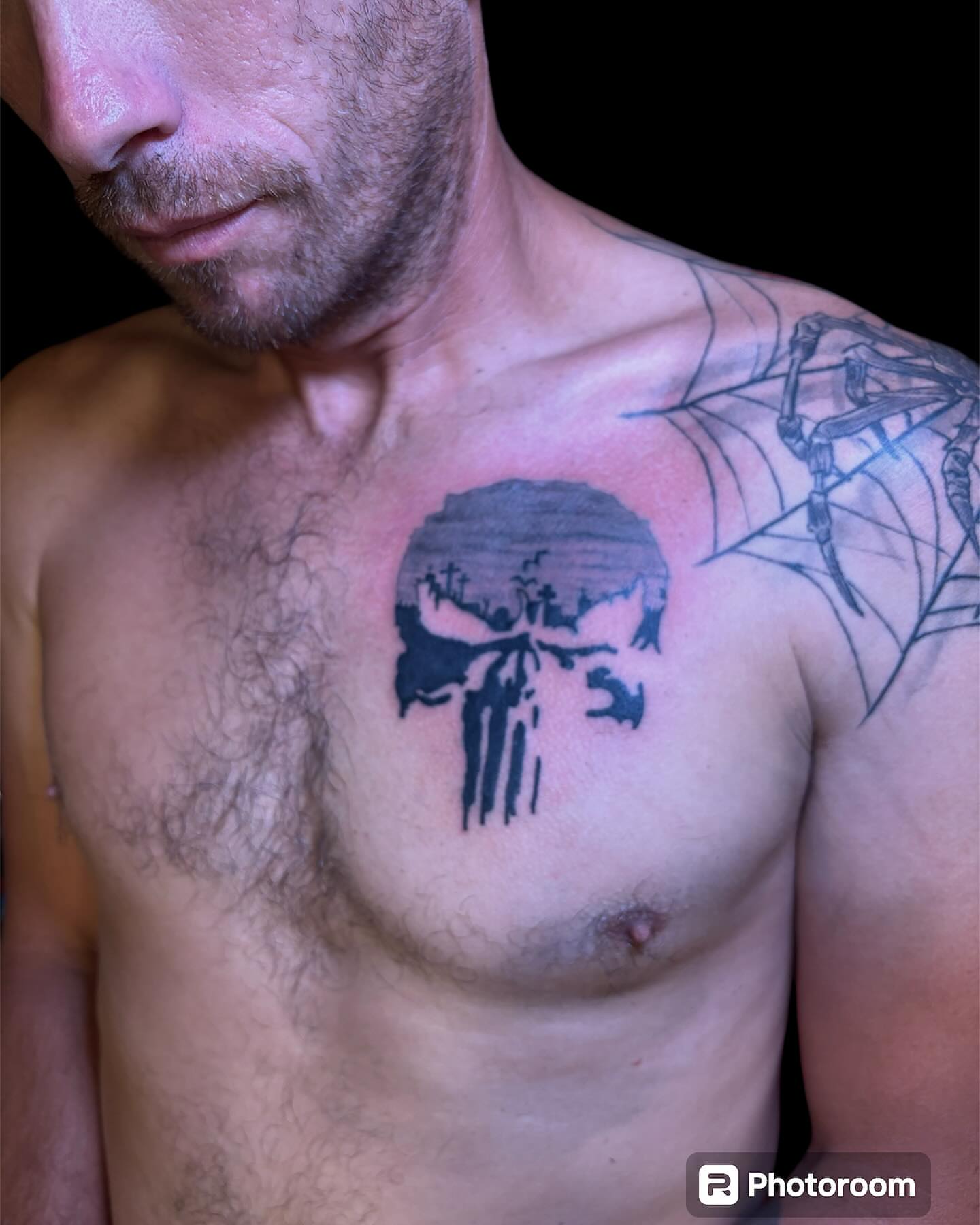 Punisher skull black and grey tattoo on the chest by Dale Martin