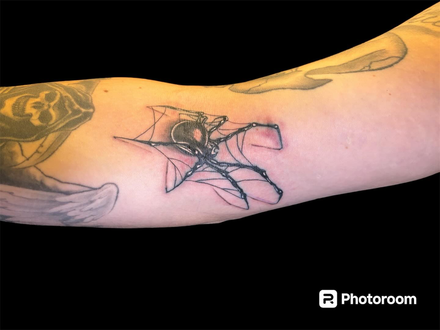 Bat black and grey tattoo on the forearm by Dale Martin