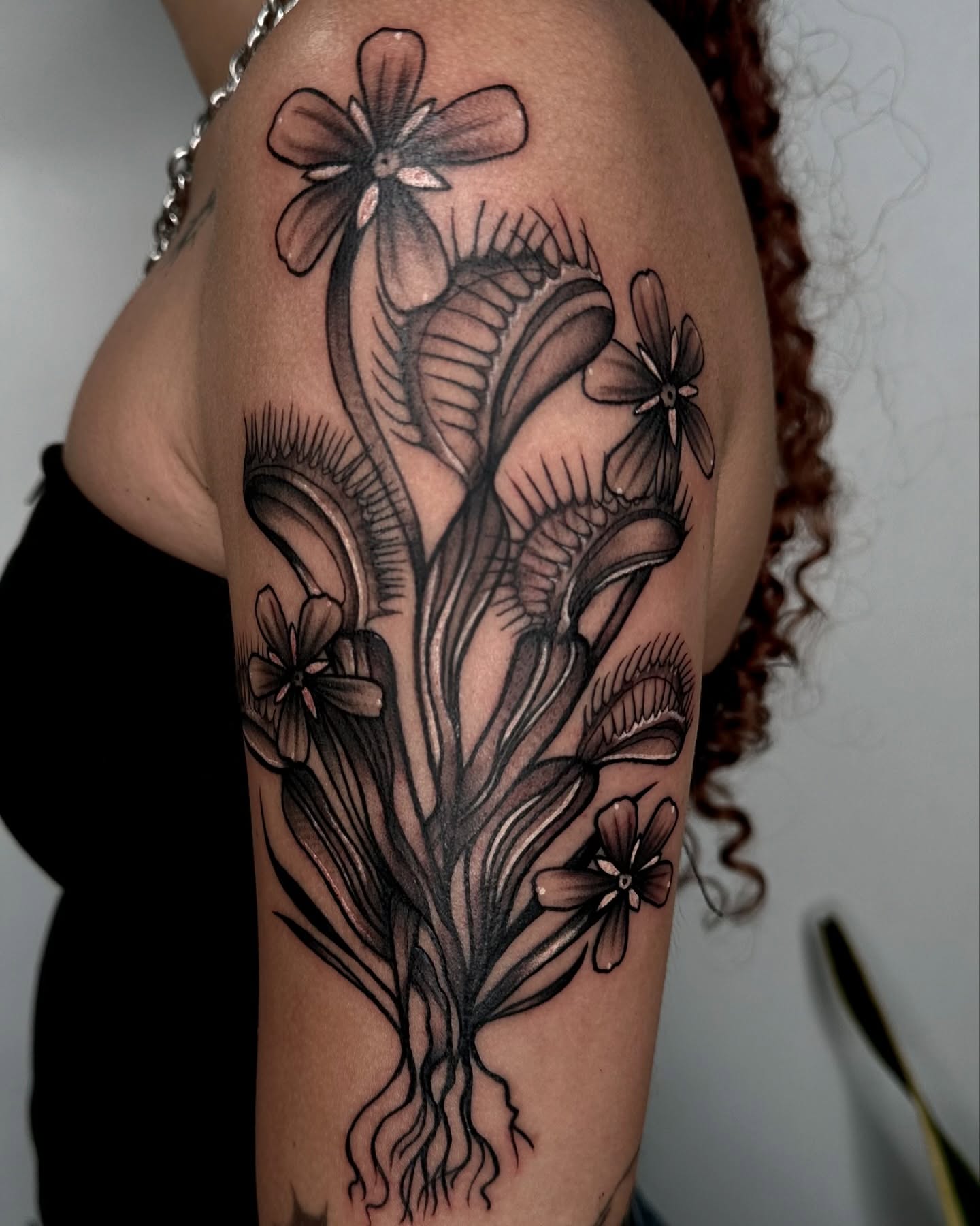 Floral bouquet black and grey tattoo on the upper arm by ✮ Monarch Tattoos ✮