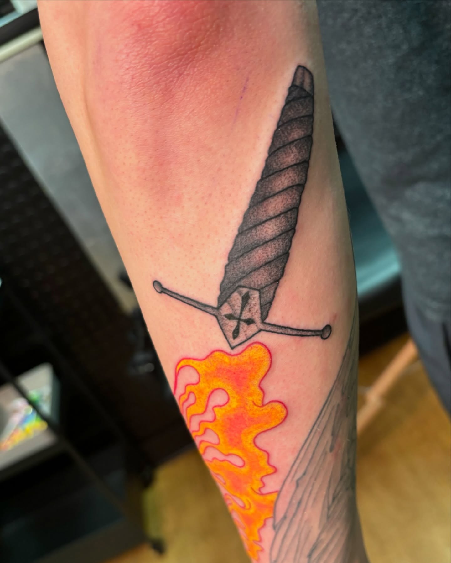 Sword black and grey tattoo on the forearm by Jordan Wray