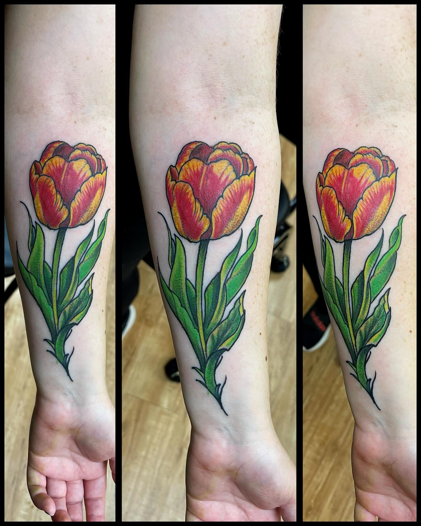 Tulip realism tattoo on the forearm by Bill Ferguson