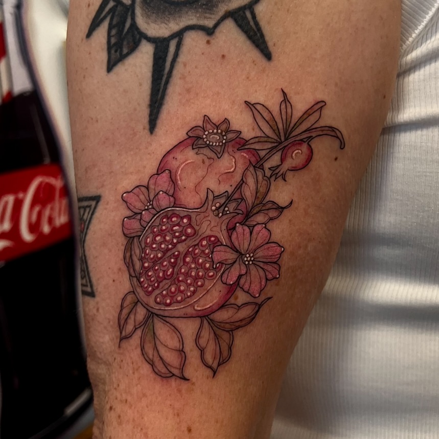 Pomegranate realism tattoo on the forearm by ✨ Jaden Belle Tattoos ✨