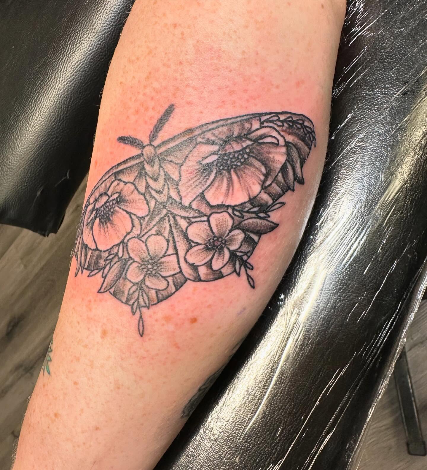 Butterfly and flowers black and grey tattoo on the forearm by Madeline, Akron, Ohio