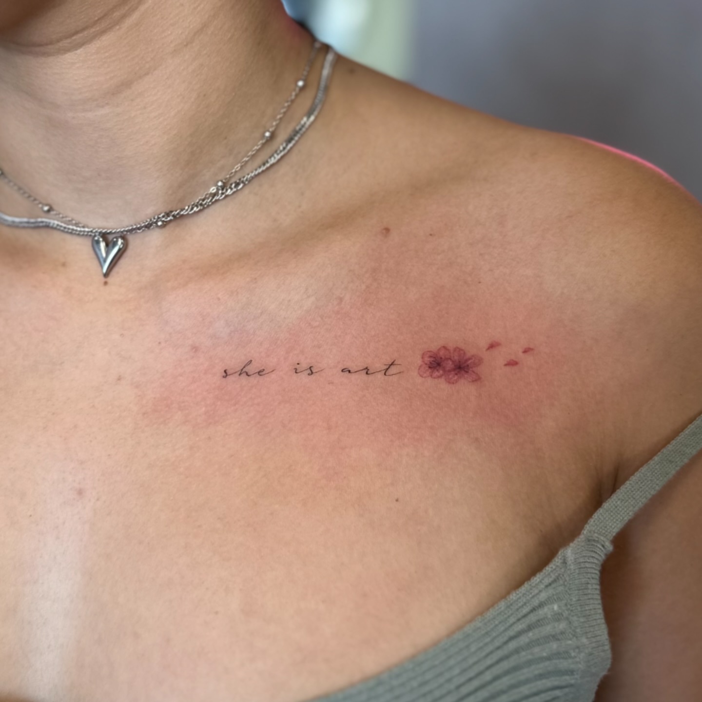She is art lettering script tattoo on the chest by Yaya Tattoos ✩ Fine Line Tattoos