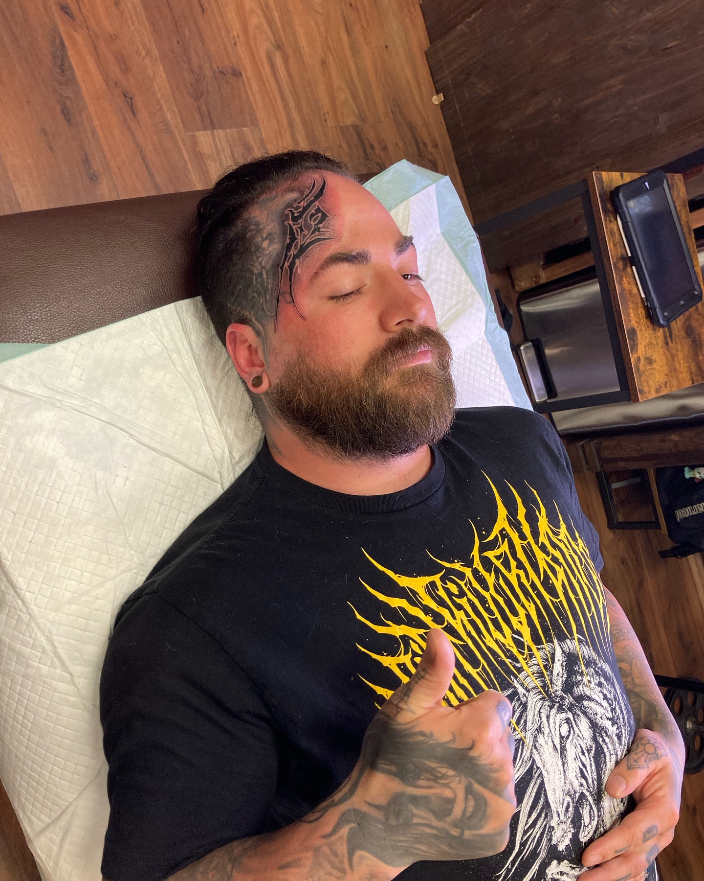 Bearded man black and grey tattoo on the head by Griffin Benson