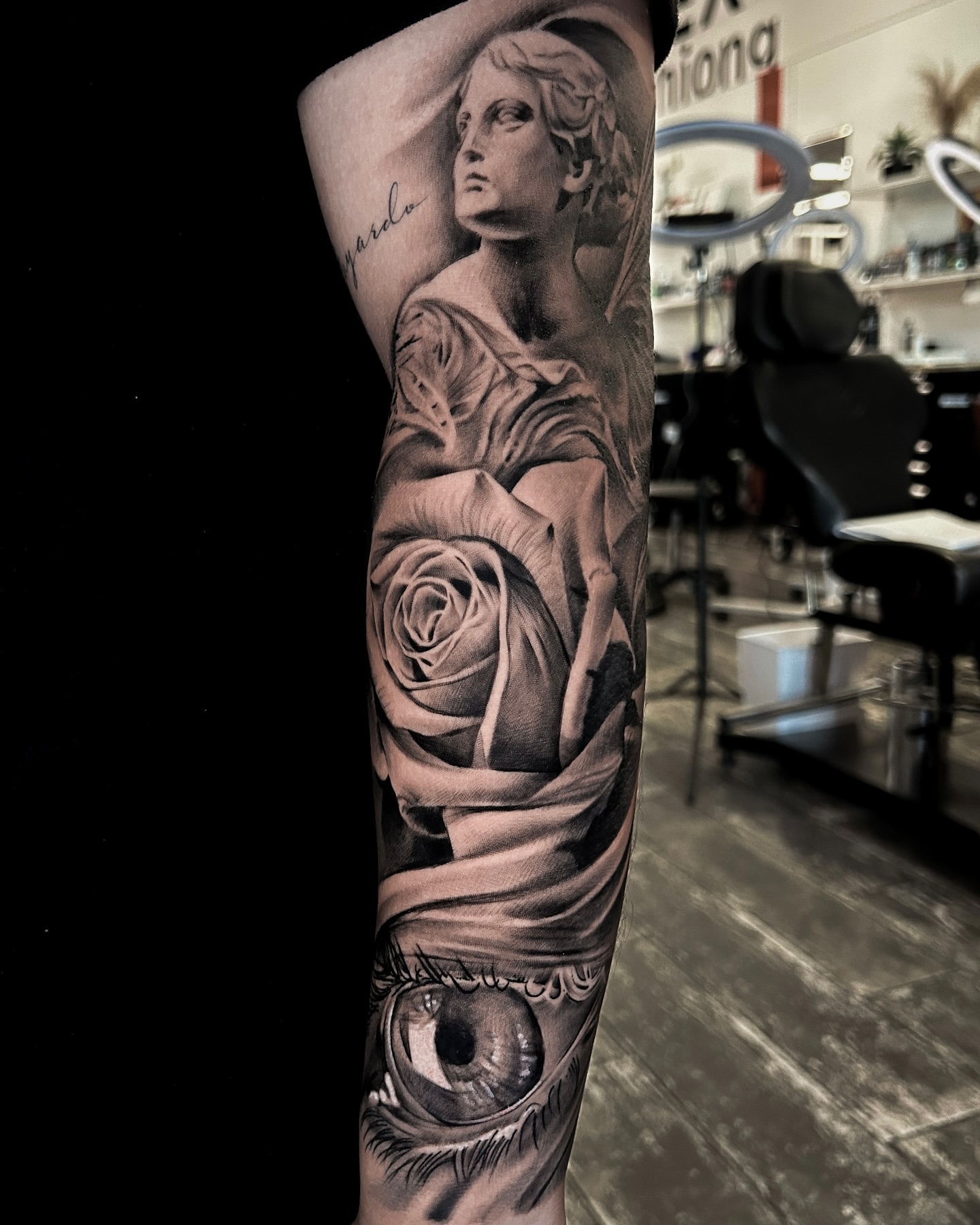 Woman with rose and eye realism tattoo on the forearm by Luis Manuel Olivera, North Miami, Florida