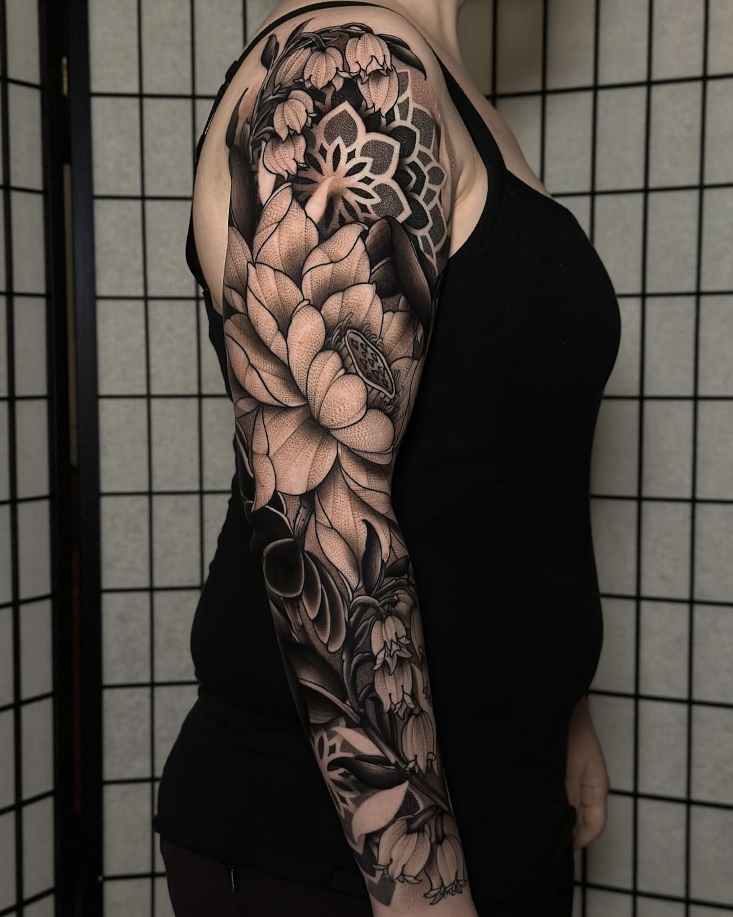 Lotus flowers realism tattoo on the upper arm by San Diego