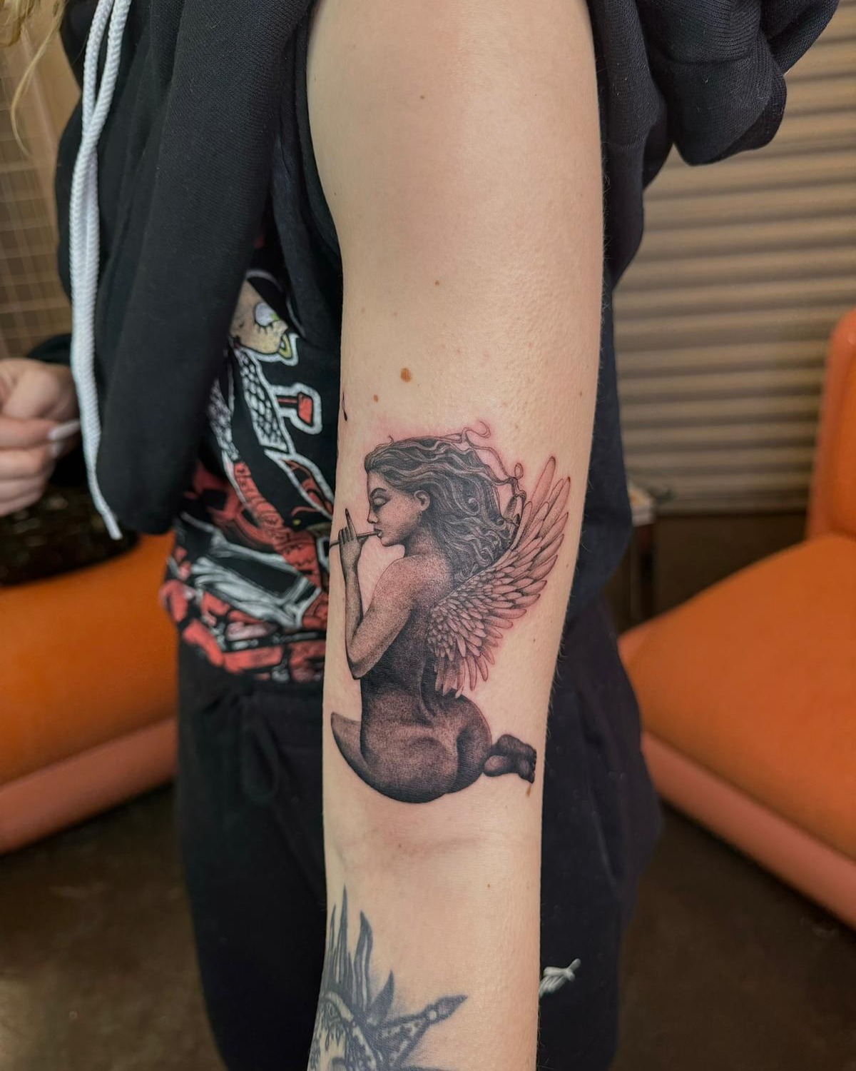 Angelic figure realism tattoo on the forearm by Ninna