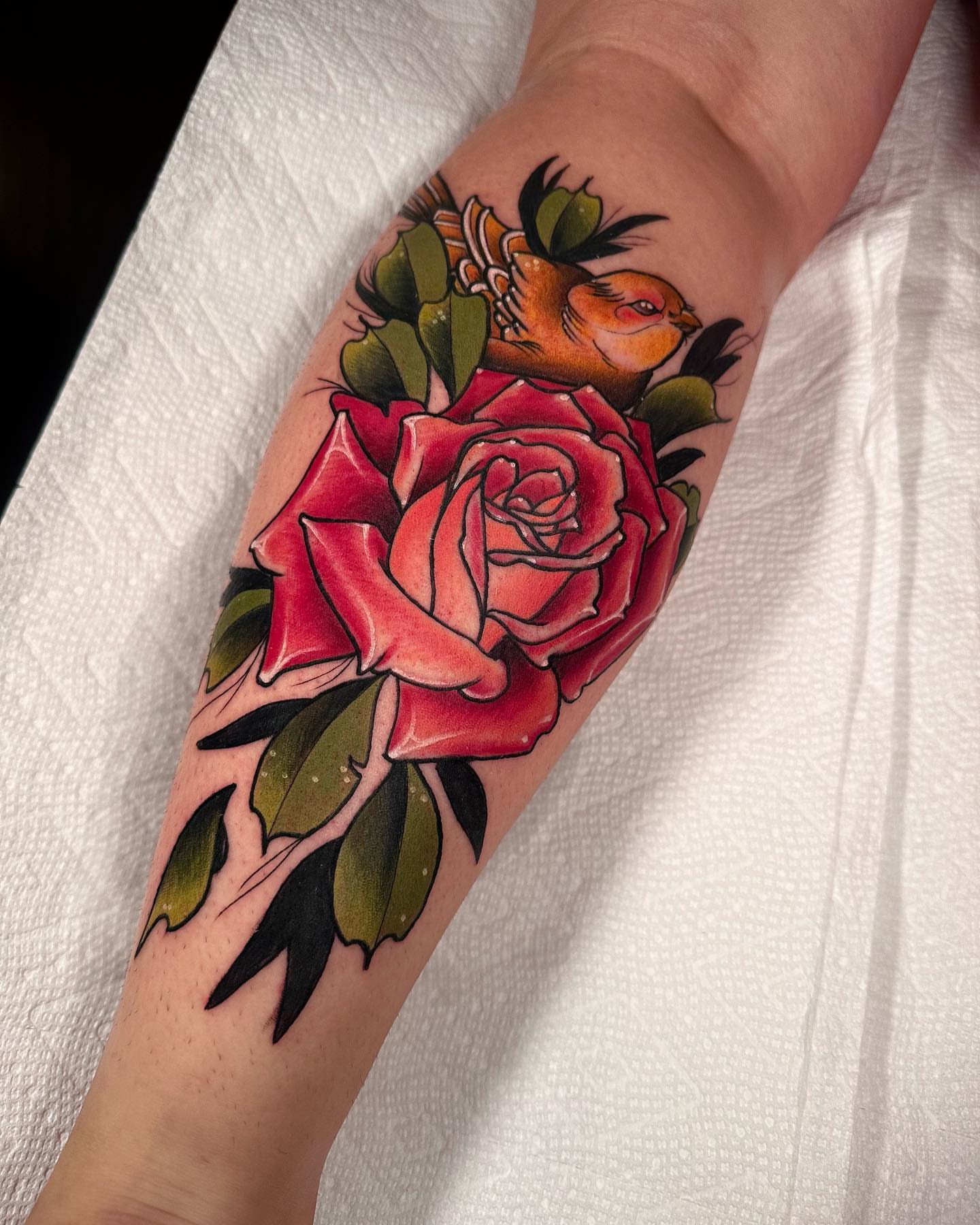 Rose and bird American traditional tattoo on the forearm by E