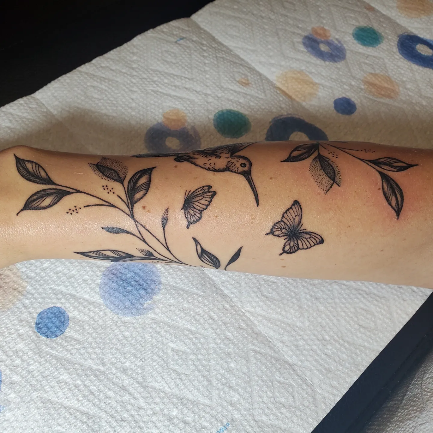 Bird and butterflies black and grey tattoo on the forearm by Shailey Pasquale