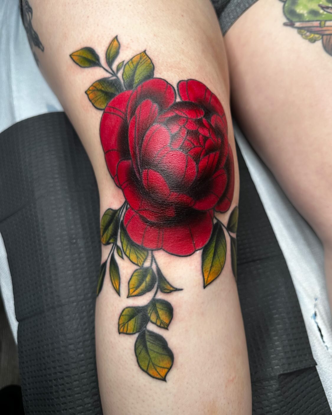 Red rose realism tattoo on the forearm by Emersyn DeLuna