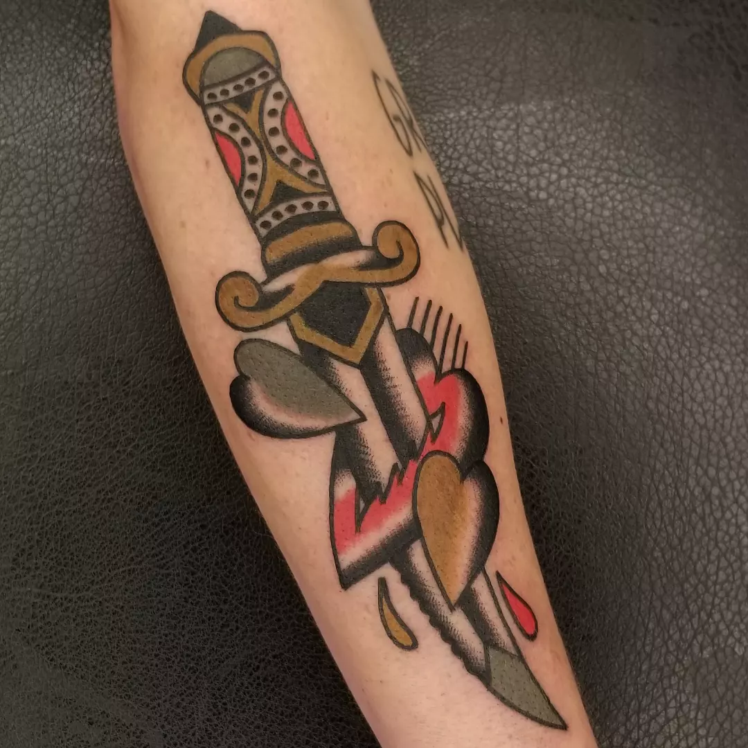 Knife piercing heart American traditional tattoo on the forearm by Deke Harms, Bend, Oregon