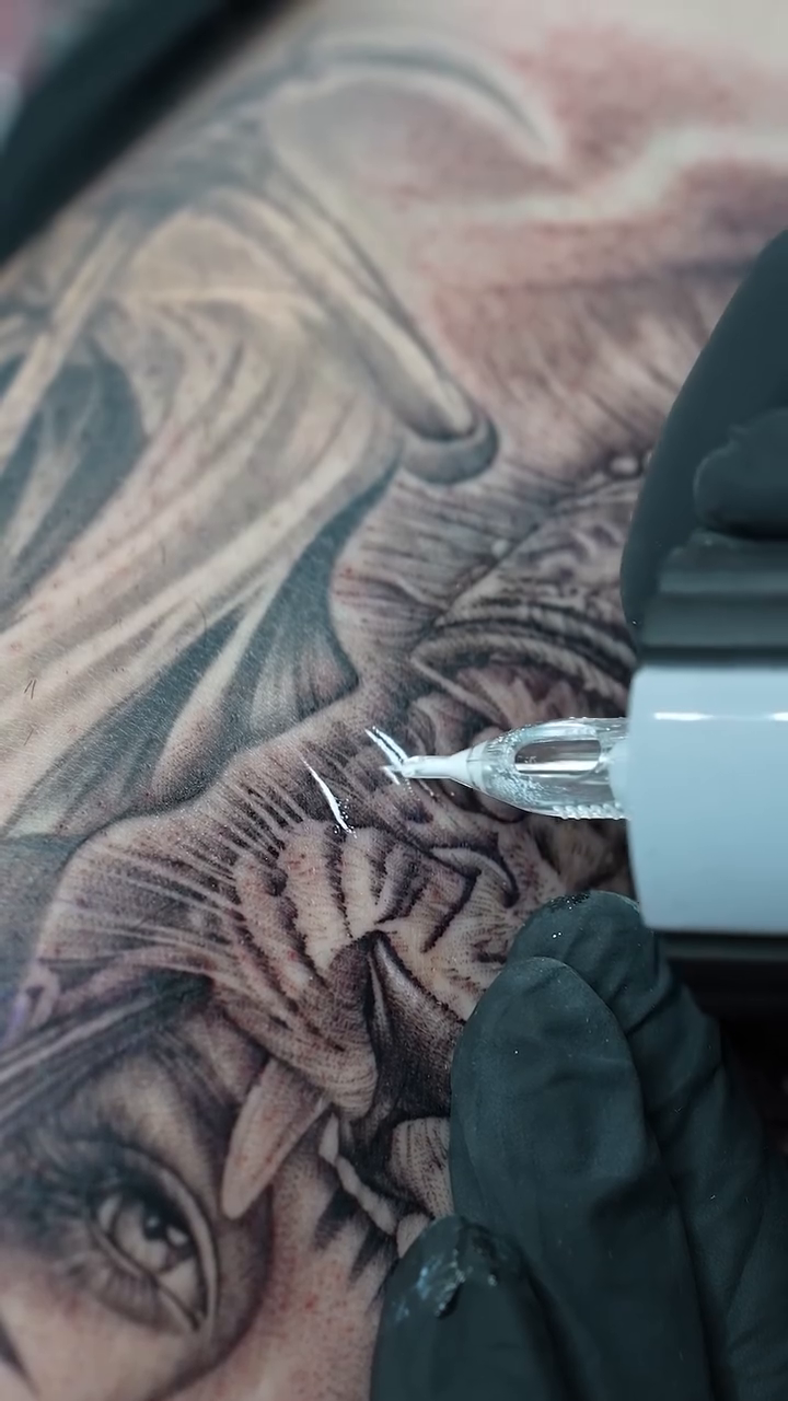 Woman with tiger elements realism tattoo by Ethan Hubbard