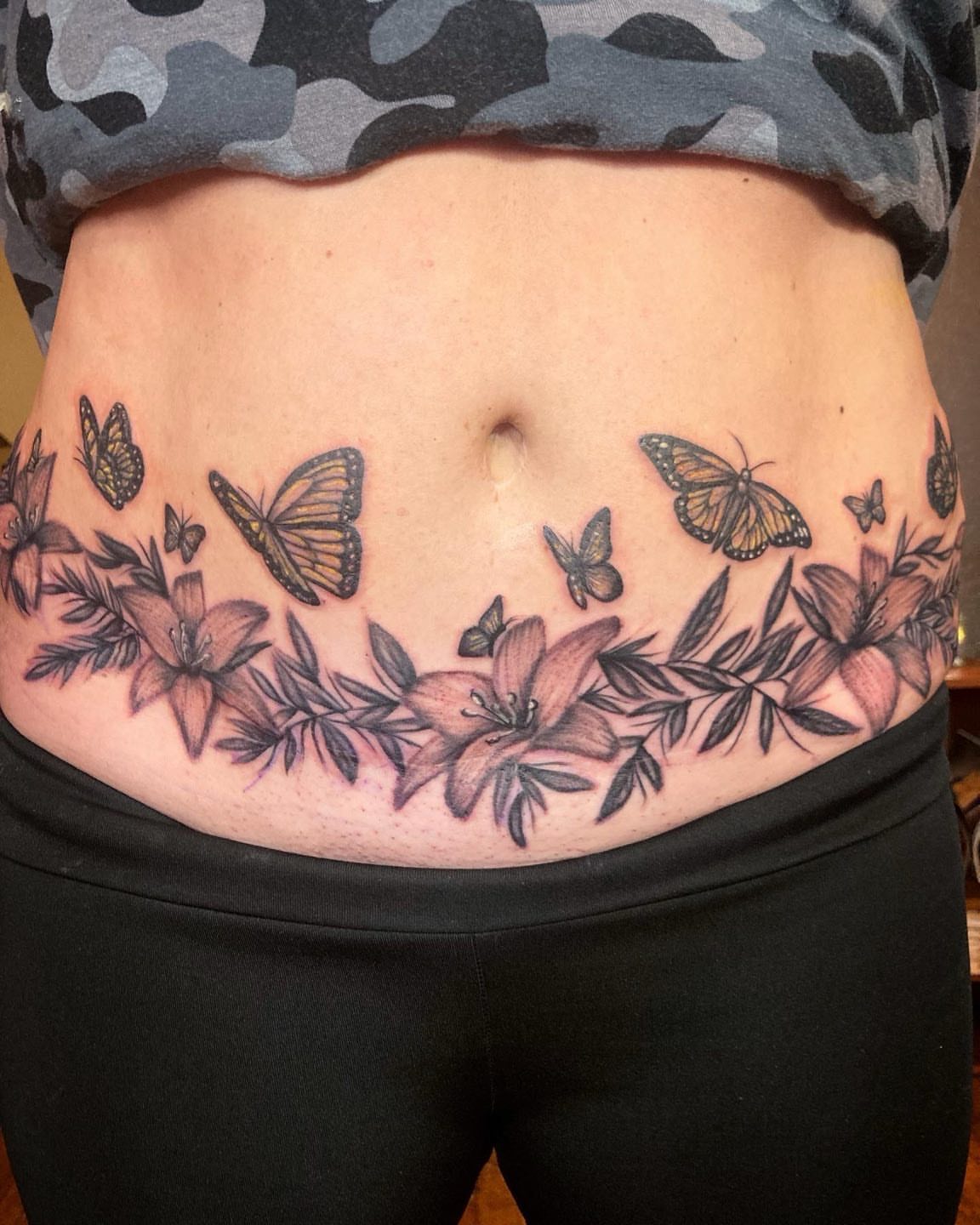 Butterflies and flowers realism tattoo on the torso by Madeline, Akron, Ohio