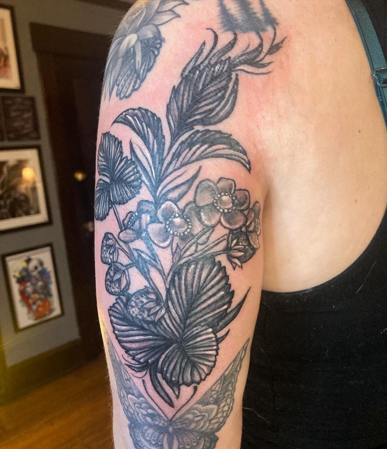 Butterflies and flowers black and grey tattoo on the upper arm by Madeline, Akron, Ohio