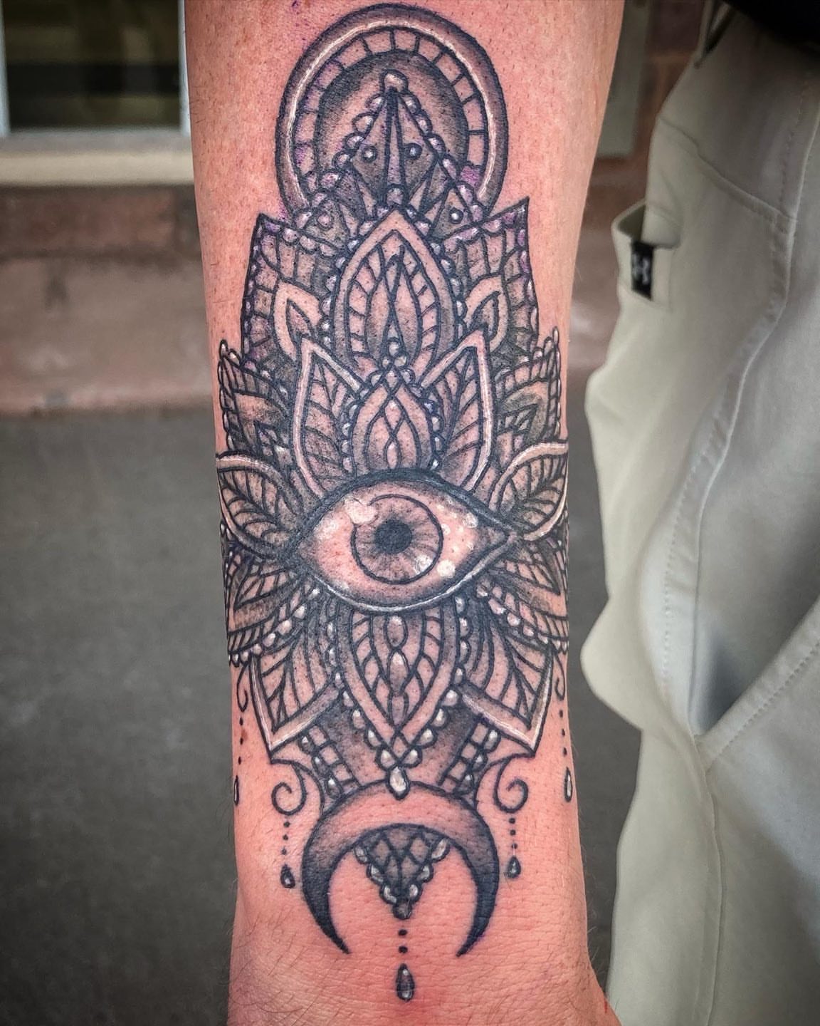 Eye and mandala geometric tattoo on the forearm by Madeline, Akron, Ohio