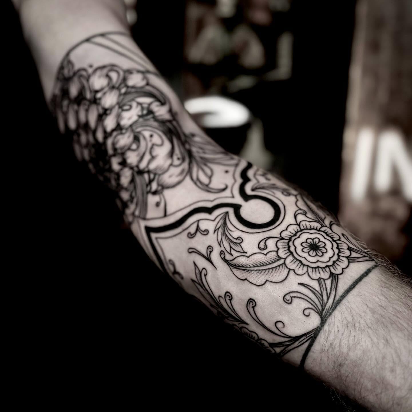 Floral pattern black and grey tattoo on the forearm by t a y l o r