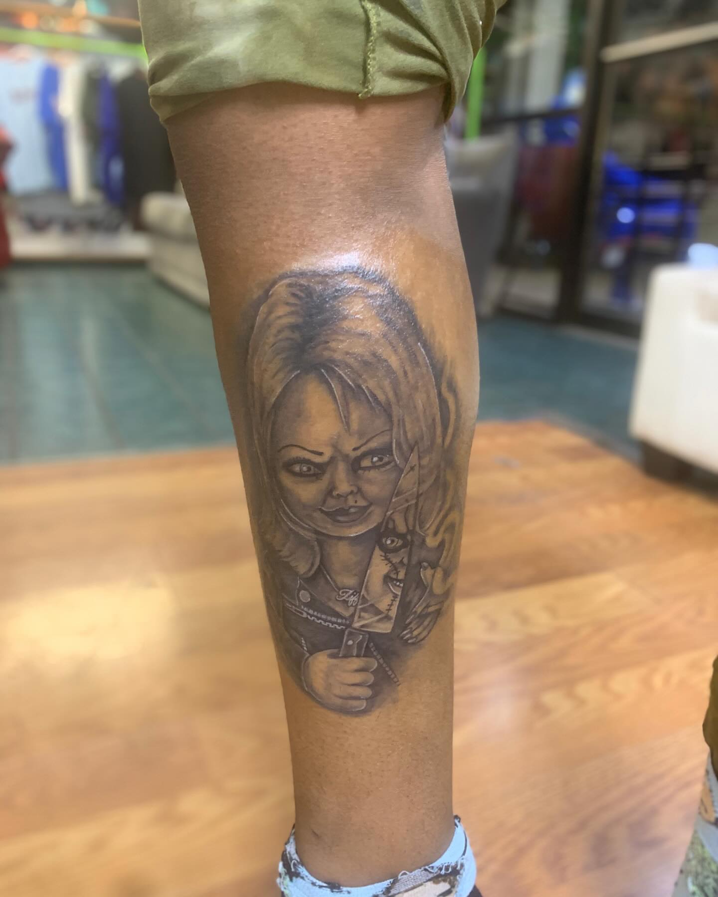 Chucky doll black and grey tattoo on the forearm by Azaan (Zanye), Birmingham, Alabama