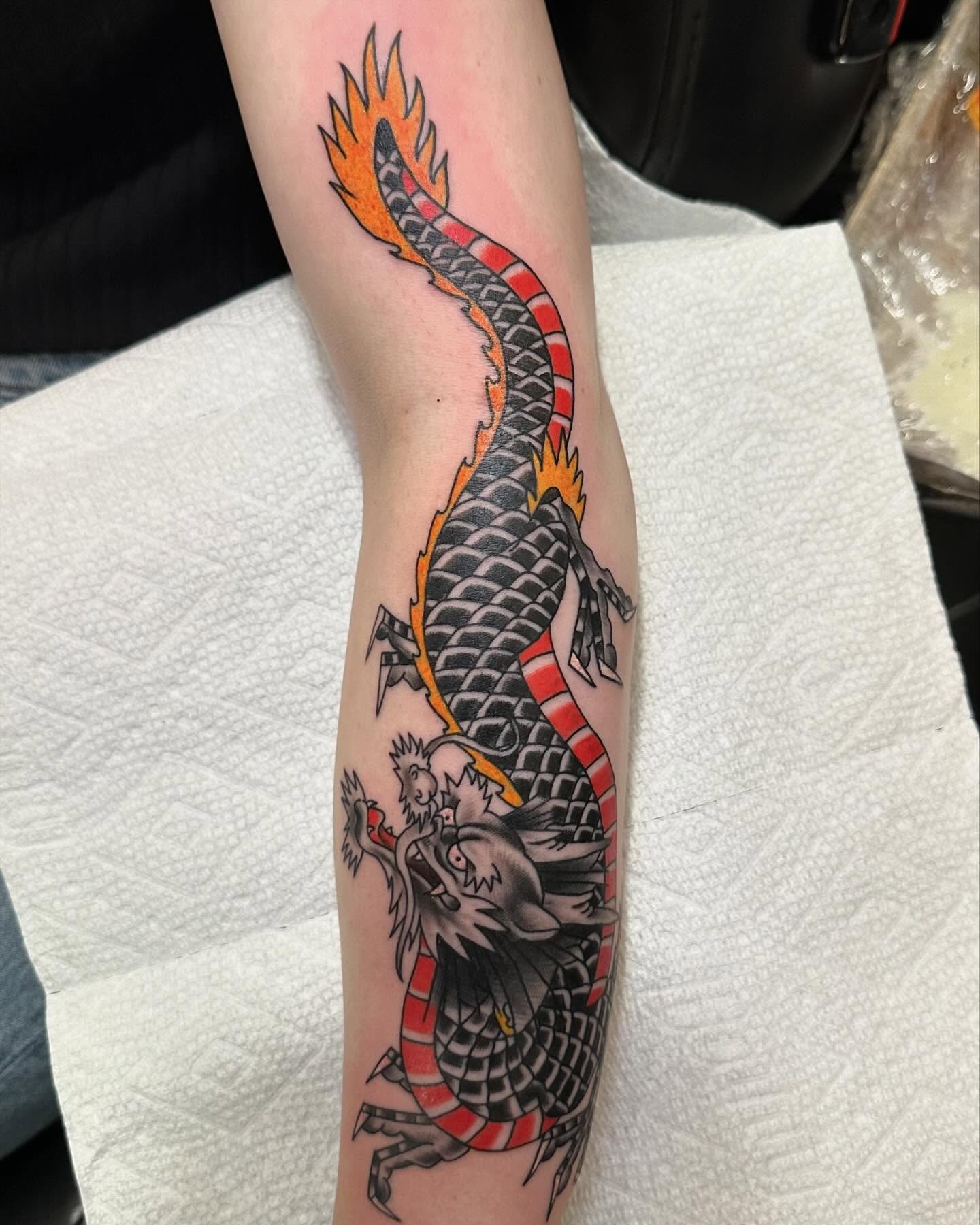 Dragon American traditional tattoo on the forearm by 𝕯𝖗𝖊𝖜 𝕲𝖎𝖑𝖊𝖘 𝕵𝖆𝖙𝖙𝖔𝖔, Addison, Texas