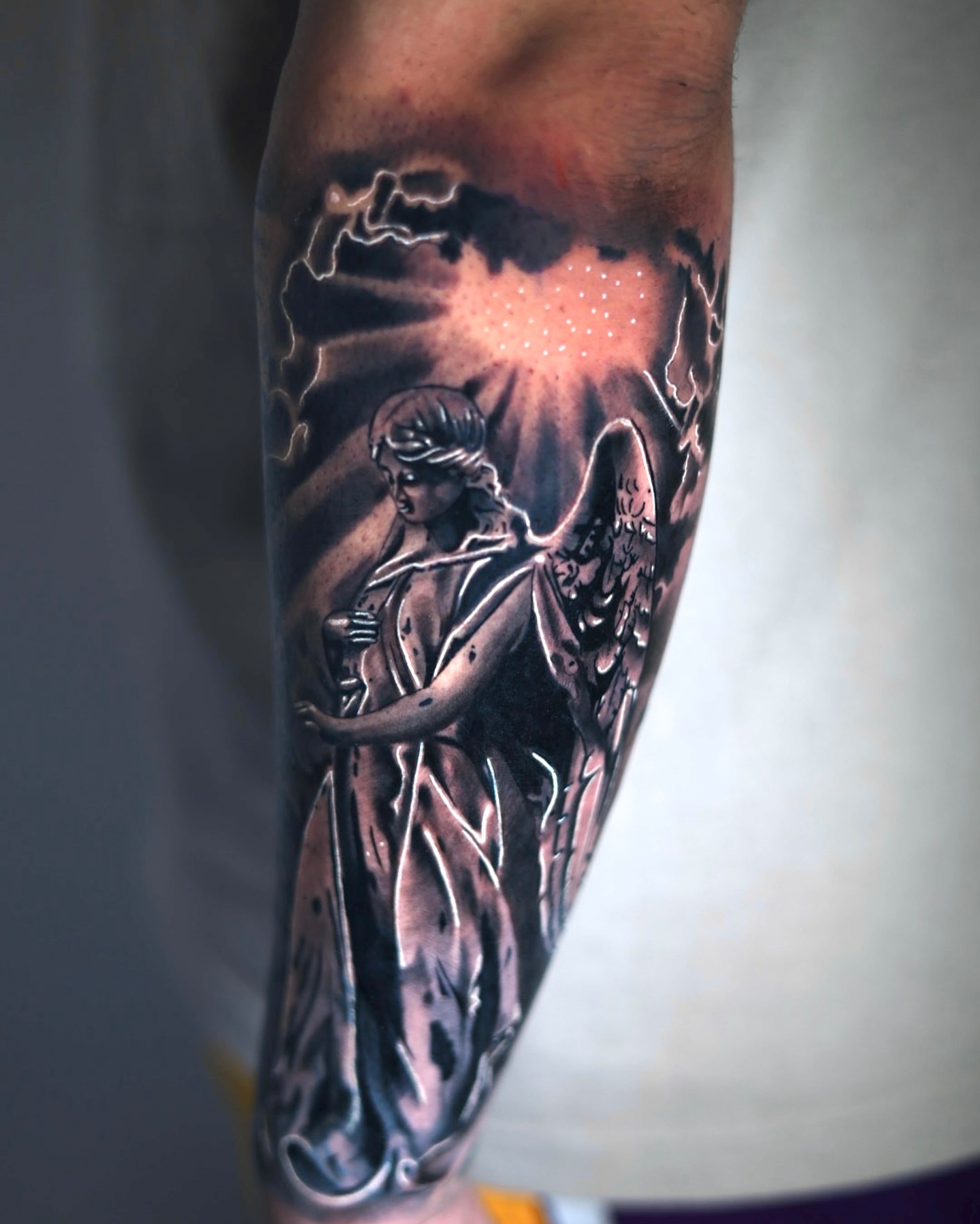 Statue of a woman realism tattoo on the forearm by Tiago Ink