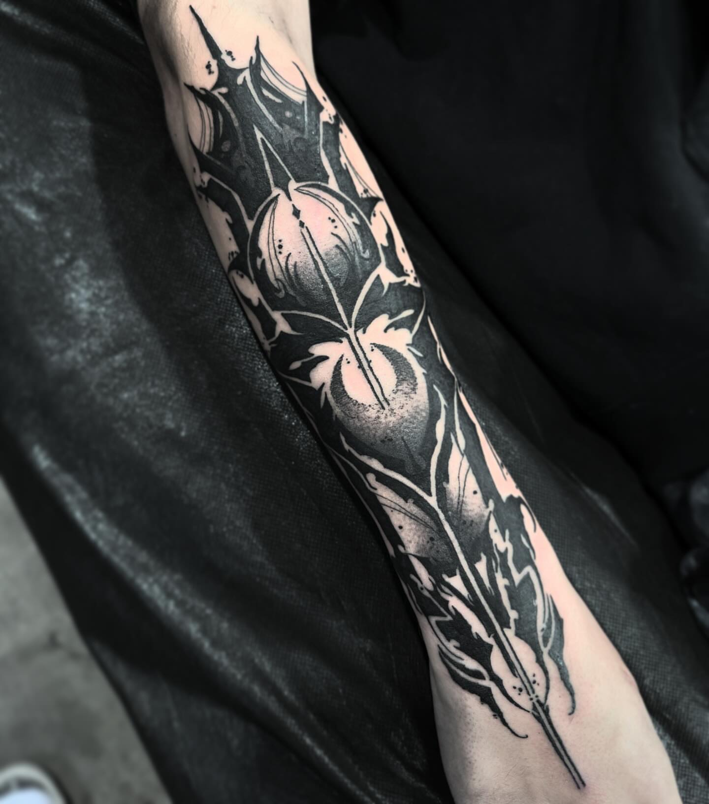 Floral design black and grey tattoo on the forearm by Jymi Calkins