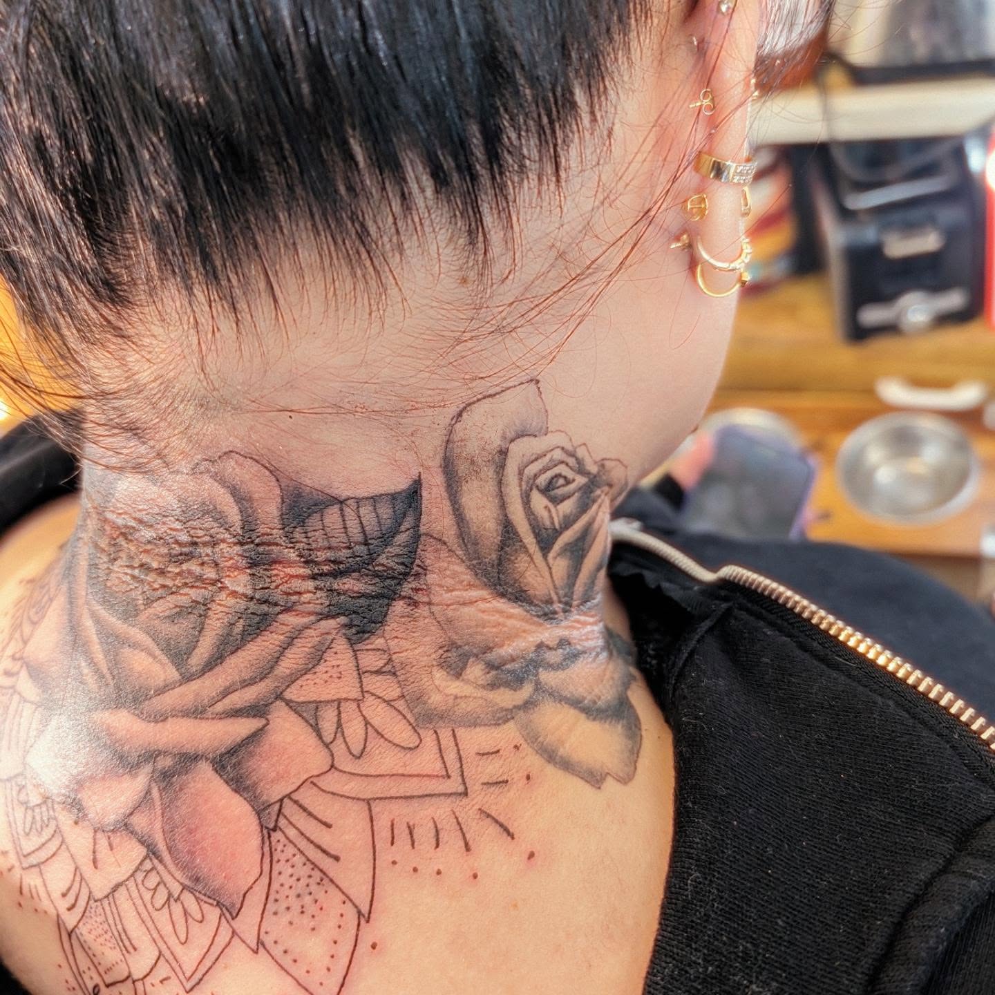 Roses realism tattoo on the neck by Markus Hicks