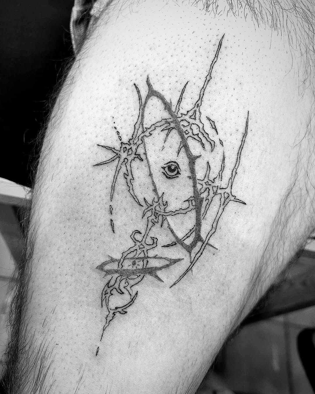 Abstract eye with thorns sketch tattoo on the thigh by Bear