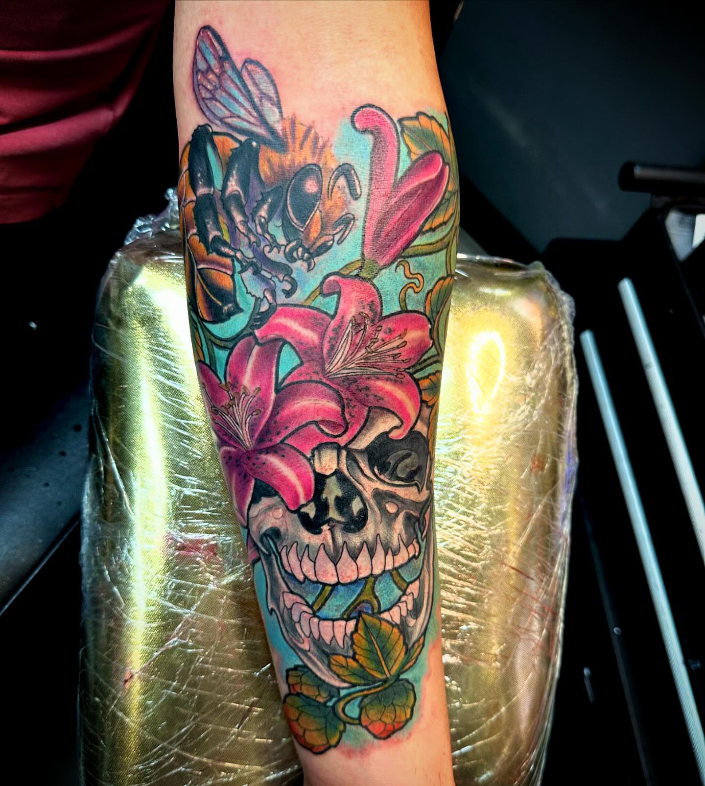 Skull with flowers American traditional tattoo on the forearm by Labbé