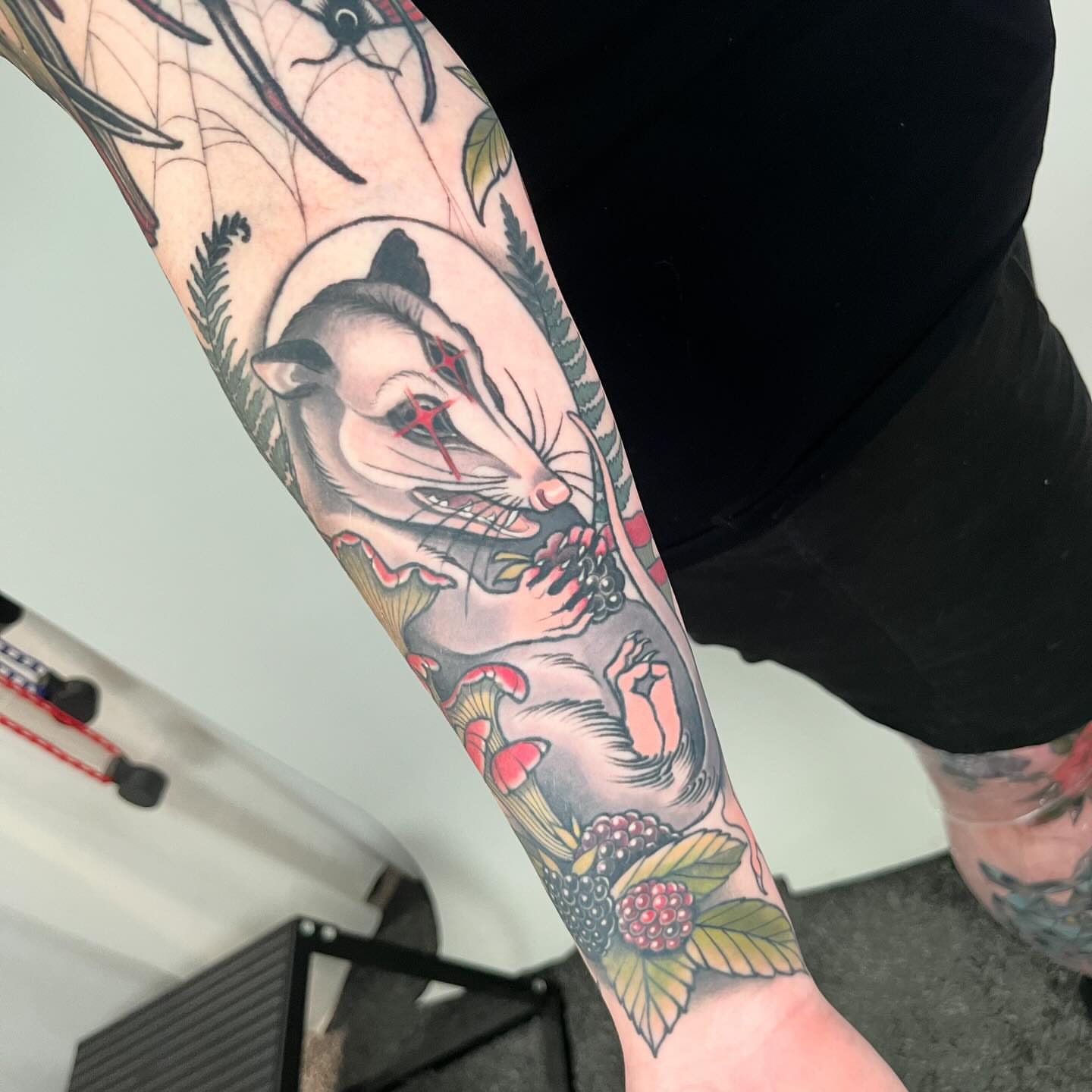 Rat and berries American traditional tattoo on the forearm by Sara Lewis