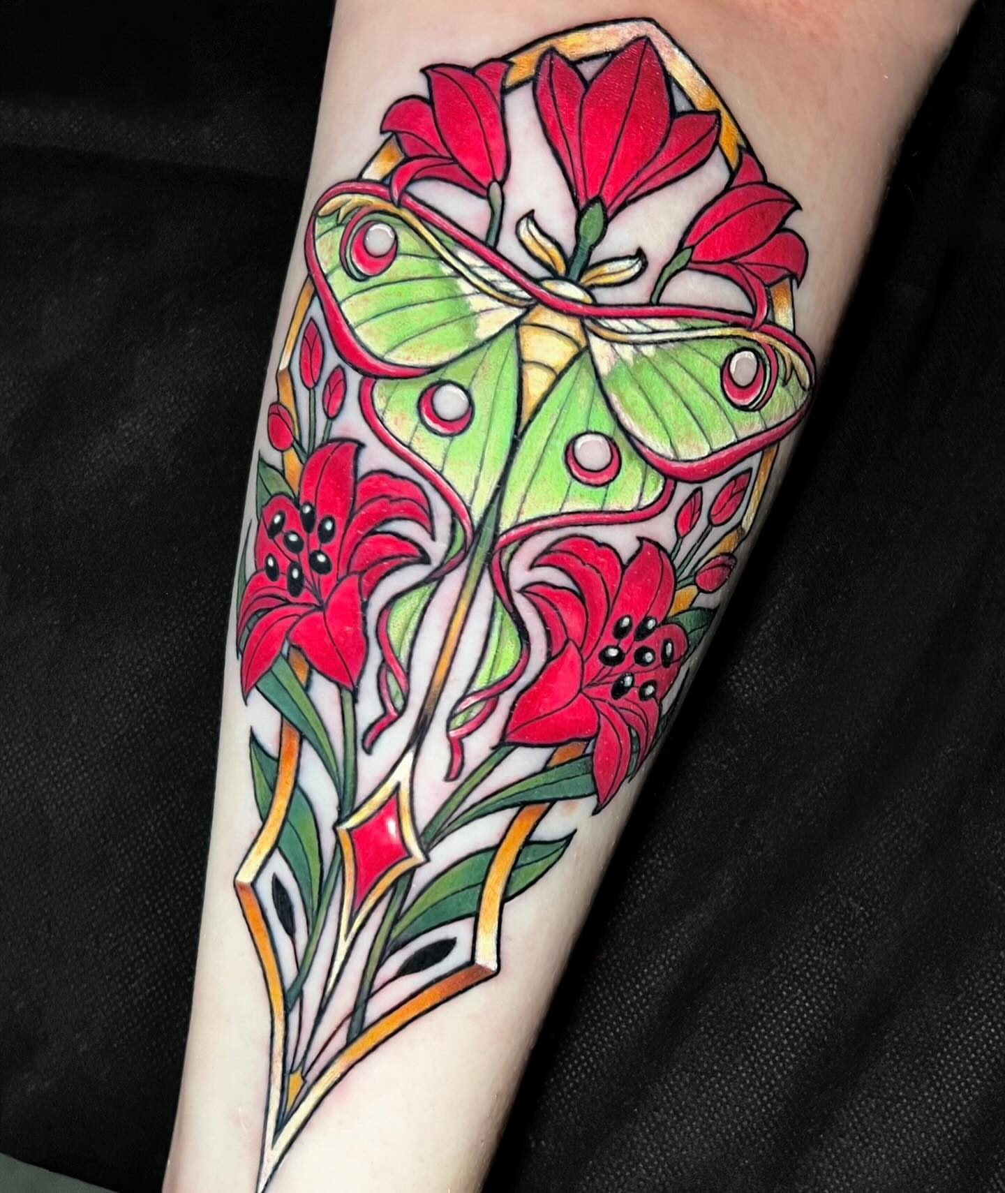 Lily moth new school tattoo on the forearm by Cortney Norton