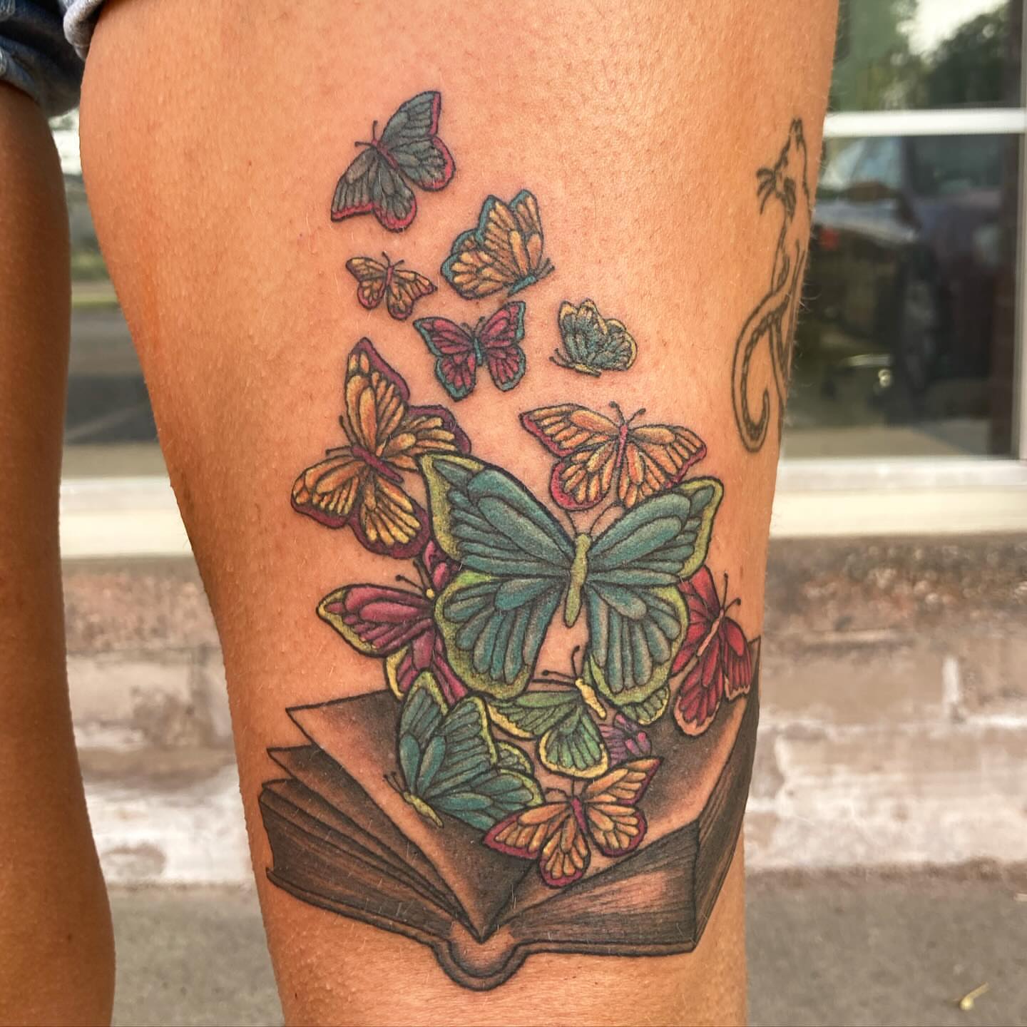 Butterflies and book new school tattoo on the leg by Madeline, Akron, Ohio
