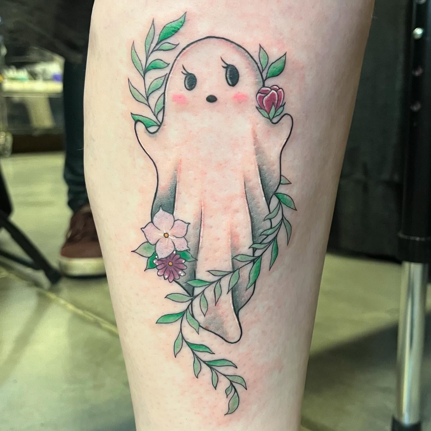 Ghost with flowers illustrative tattoo on the leg by Krystal ✨