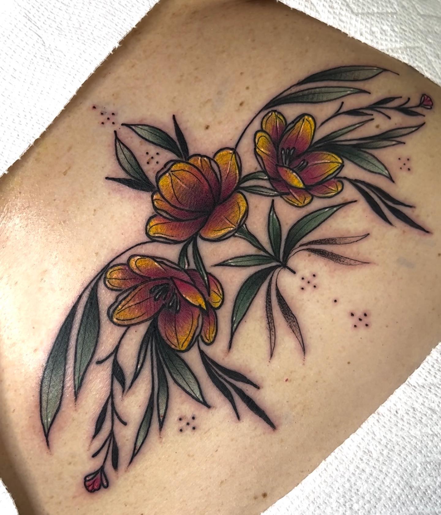 Flowers American traditional tattoo on the thigh by Tatijana., Kettering, Ohio