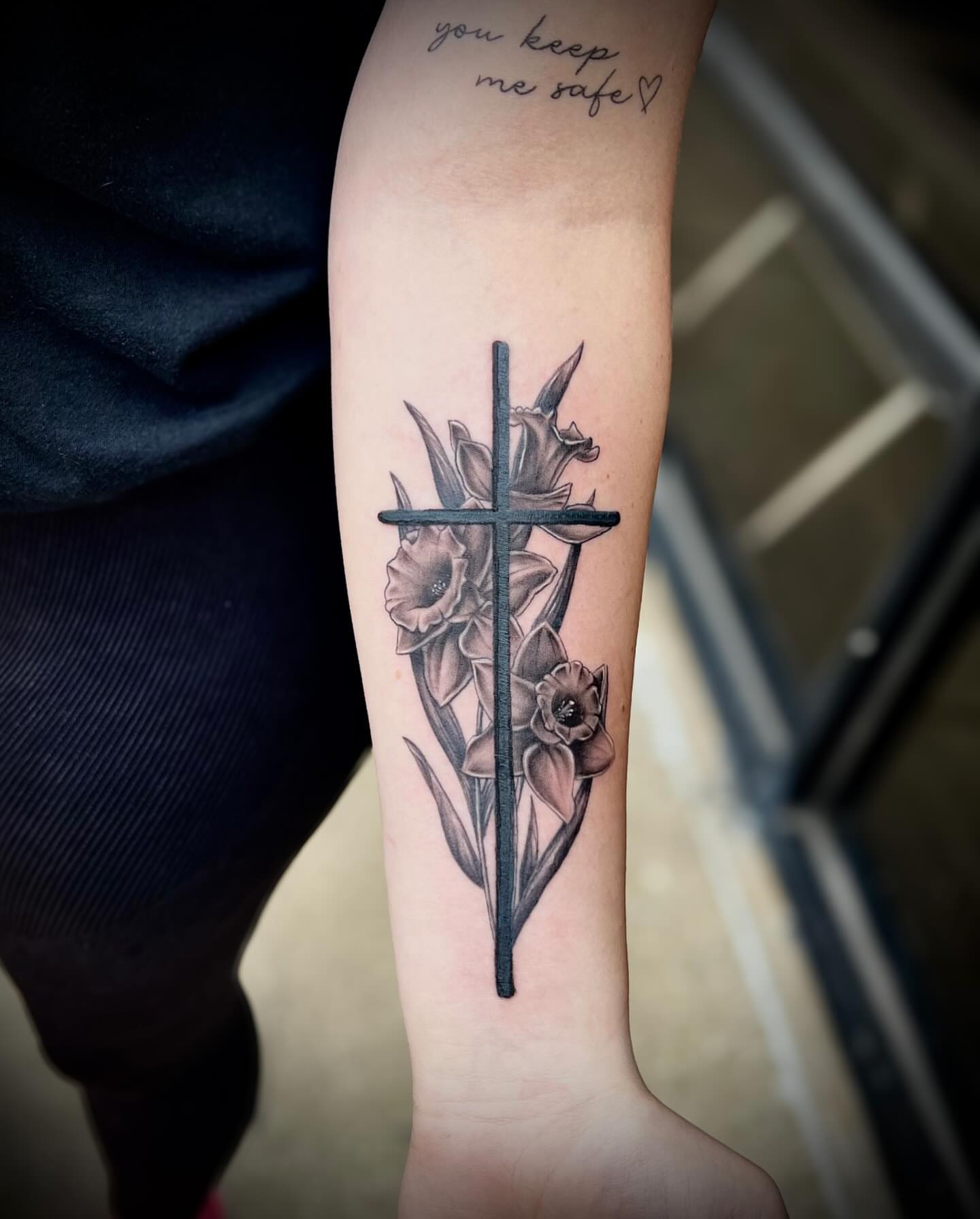 Cross with flowers black and grey tattoo on the forearm by Tattoos by Katherina, Willoughby, Ohio
