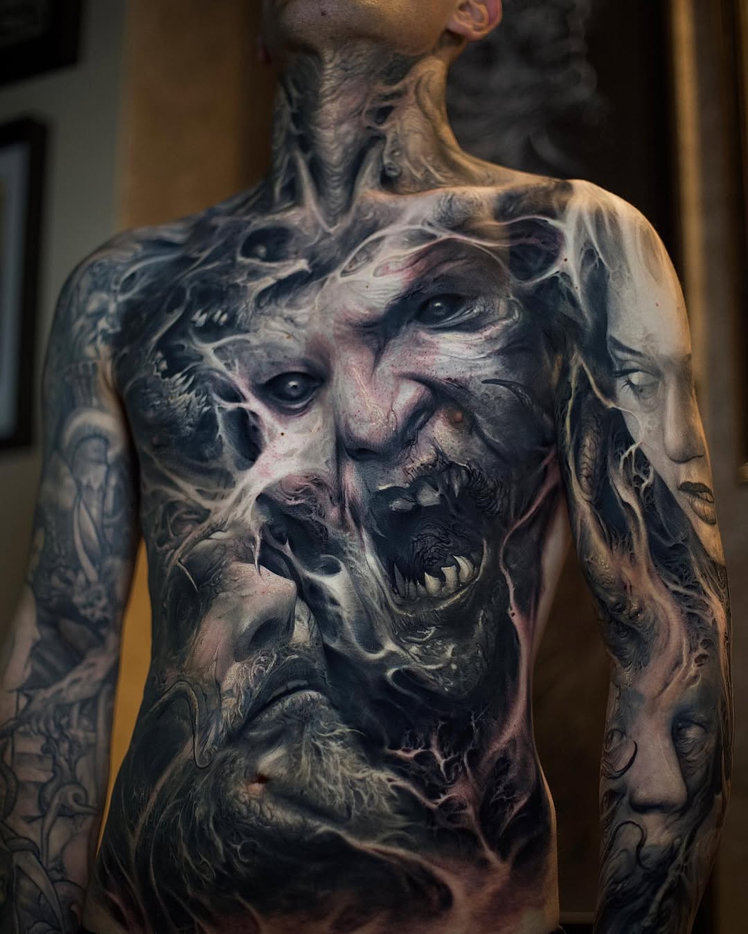 Horror faces and figures realism tattoo on the torso by David Jorquera