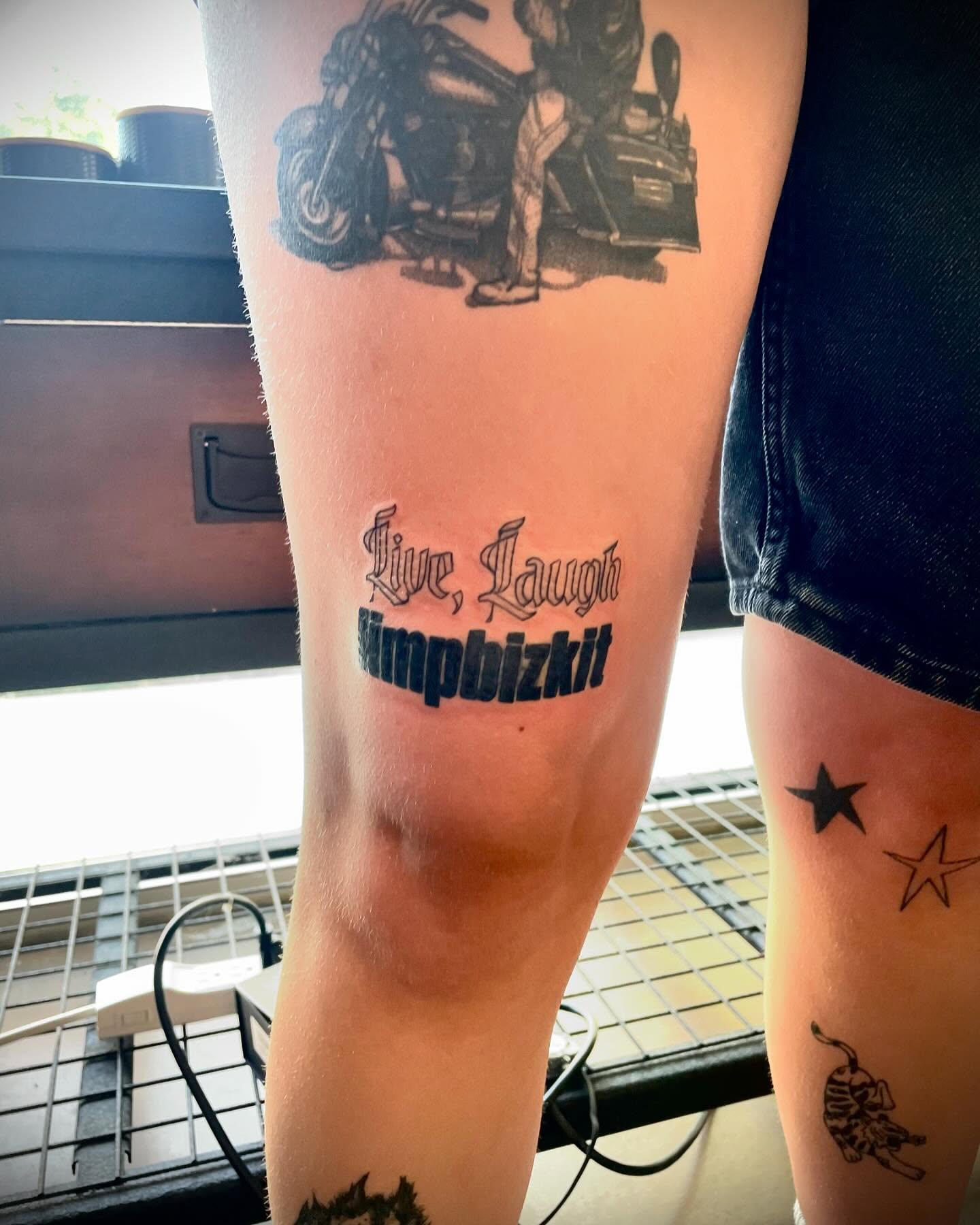 Live, Laugh, Limpbizkit black and grey tattoo on the thigh by Kaylee 🗡️