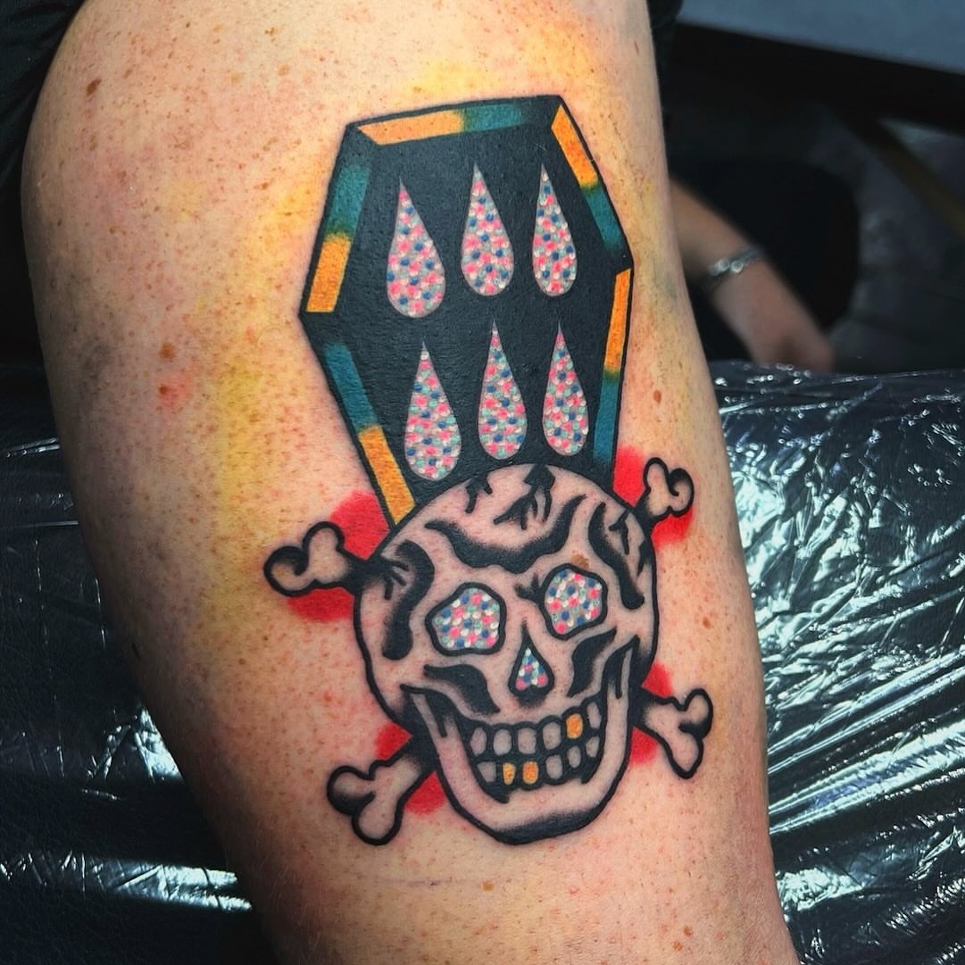 Skull and crossbones American traditional tattoo on the thigh by Benjamin Ward