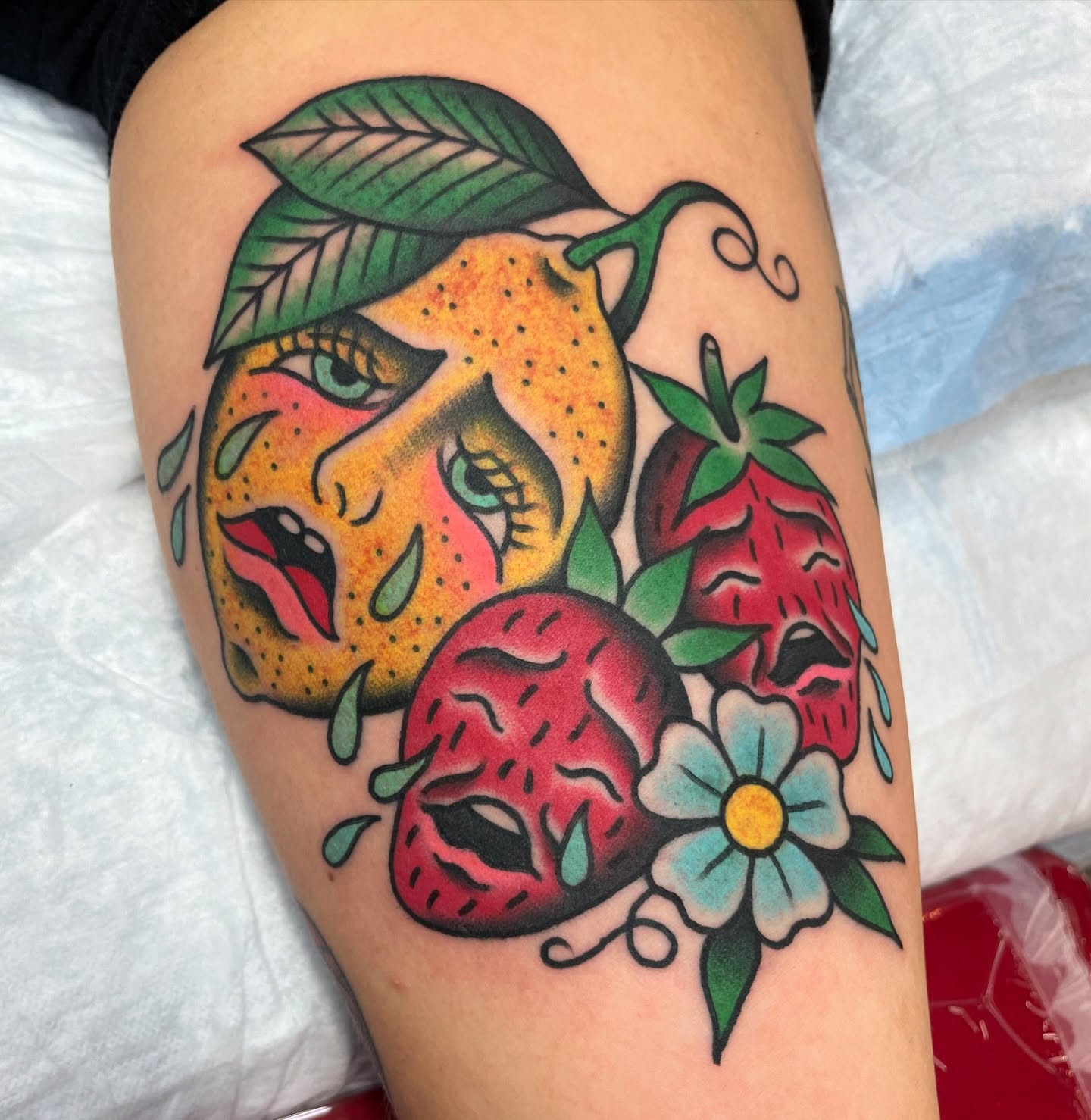 Strawberries and lemon American traditional tattoo on the thigh by Tom Taylor, Philadelphia, Pennsylvania