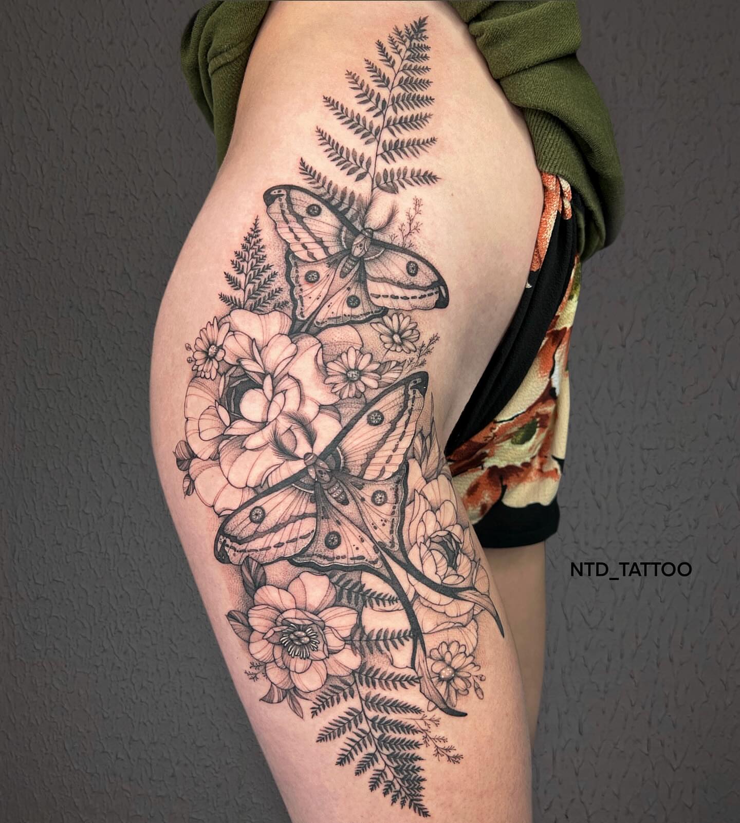 Butterflies and flowers realism tattoo on the thigh by Tetiana Maxon