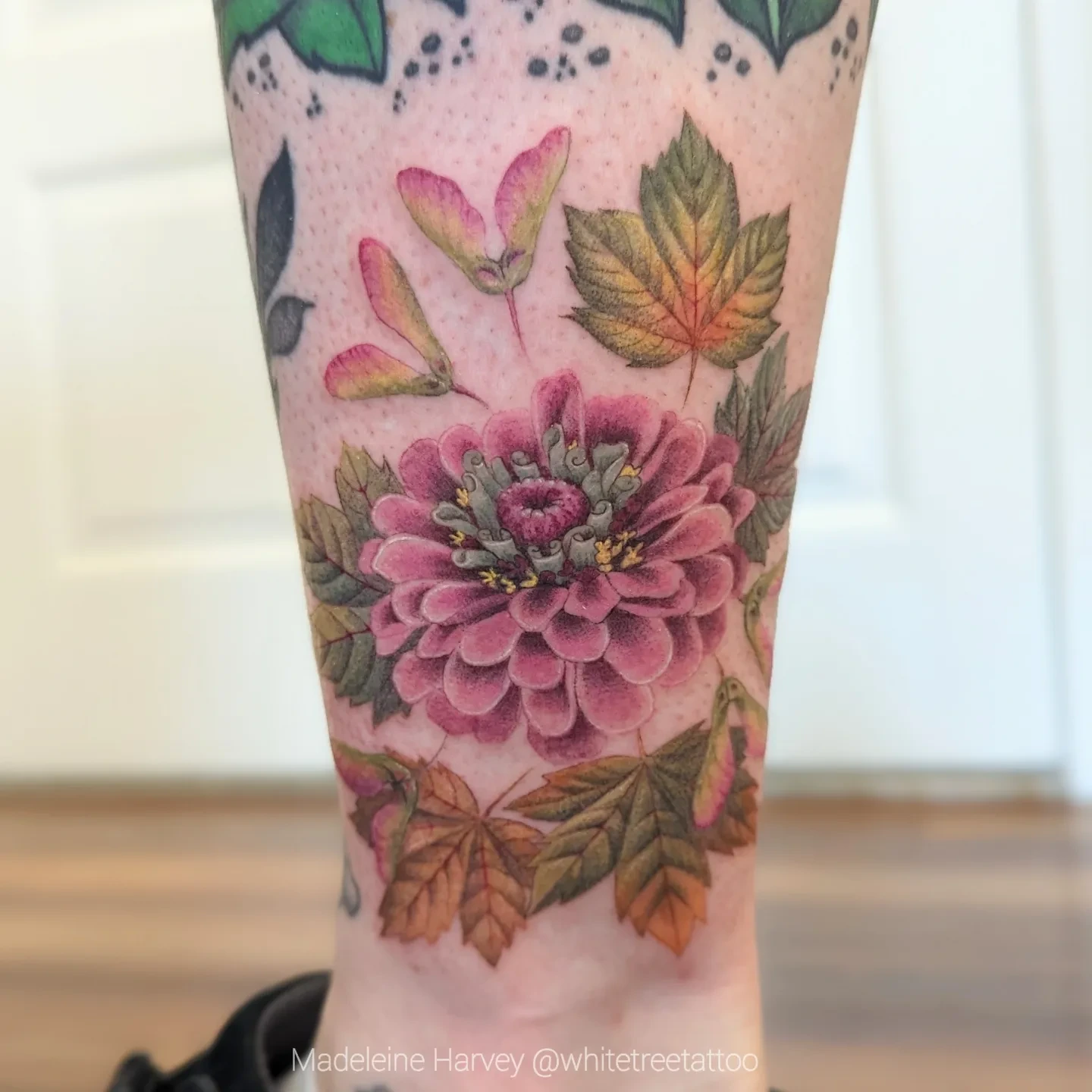 Flower realism tattoo on the calf by Maddie