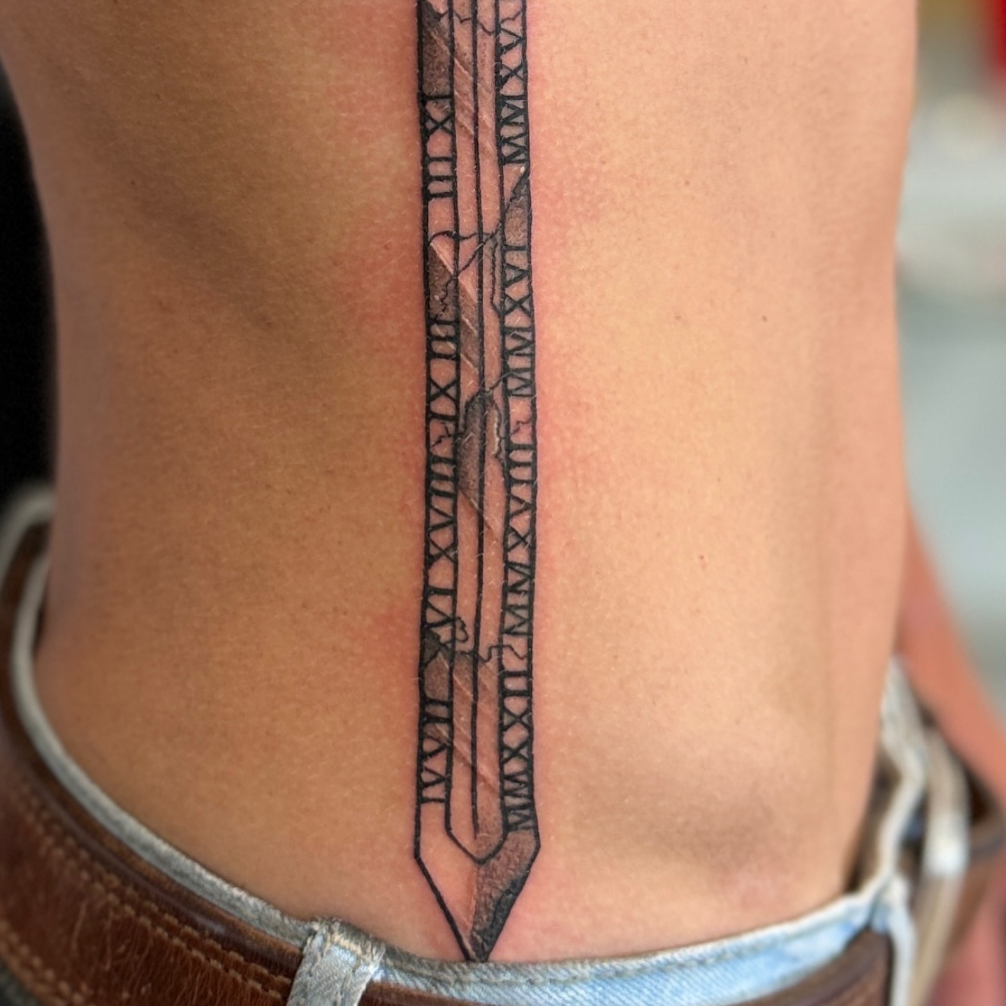 Runes black and grey tattoo on the ribs by Steve