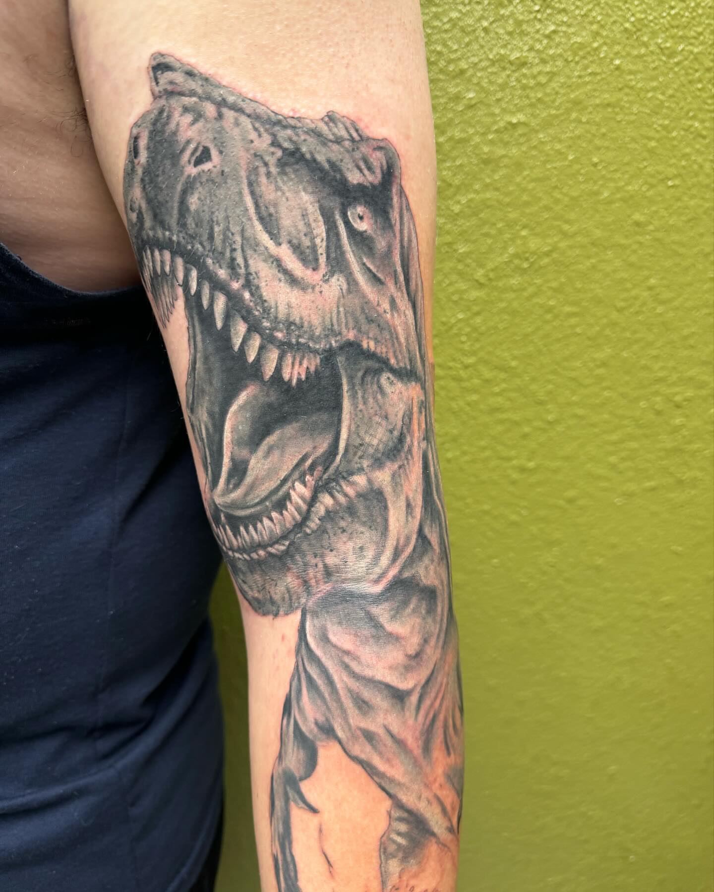 T-rex realism tattoo on the forearm by Chris Allen Taylor